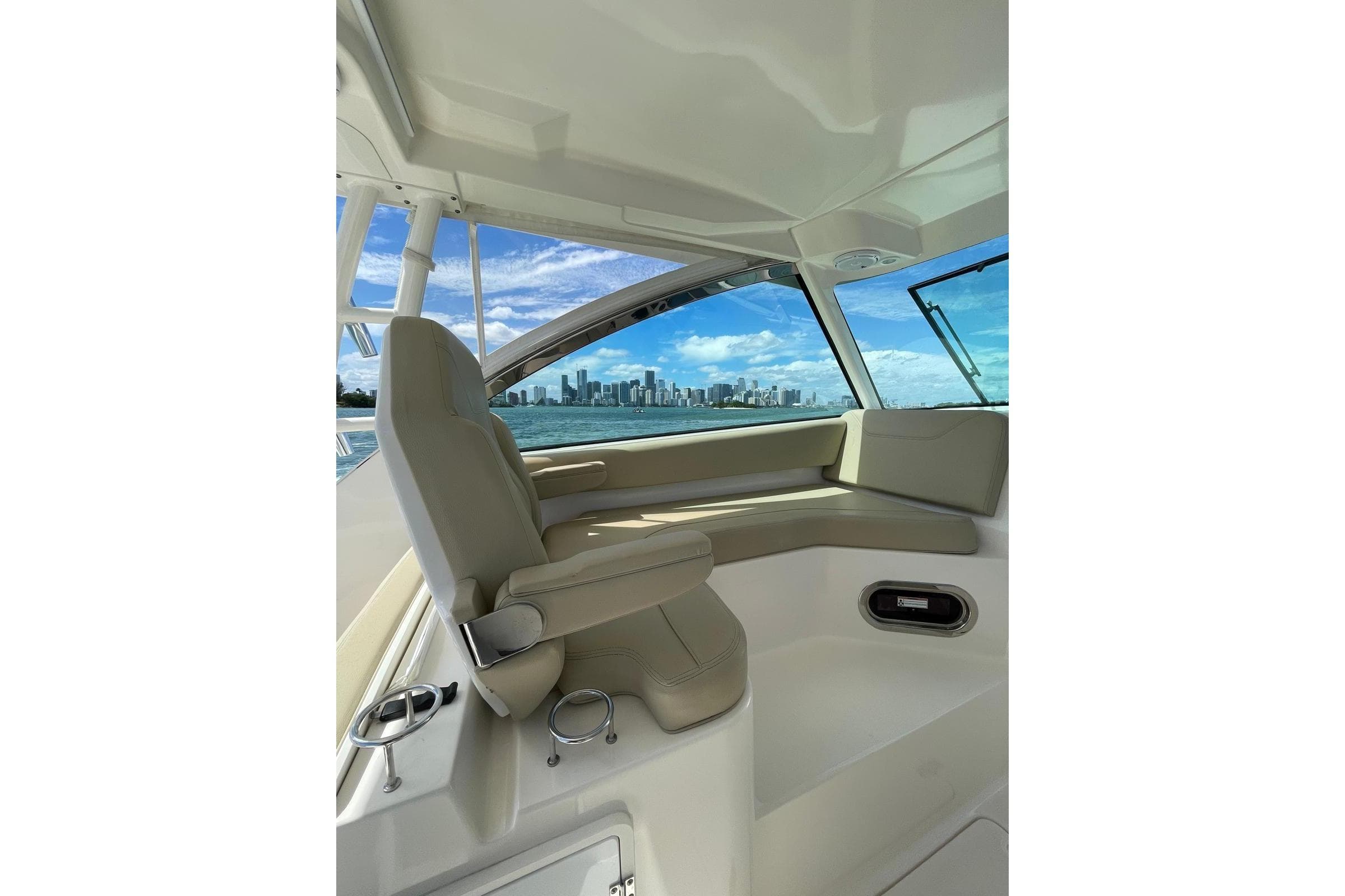 Interior of 2016 Pursuit DC 325 Dual Console boat with city skyline view.