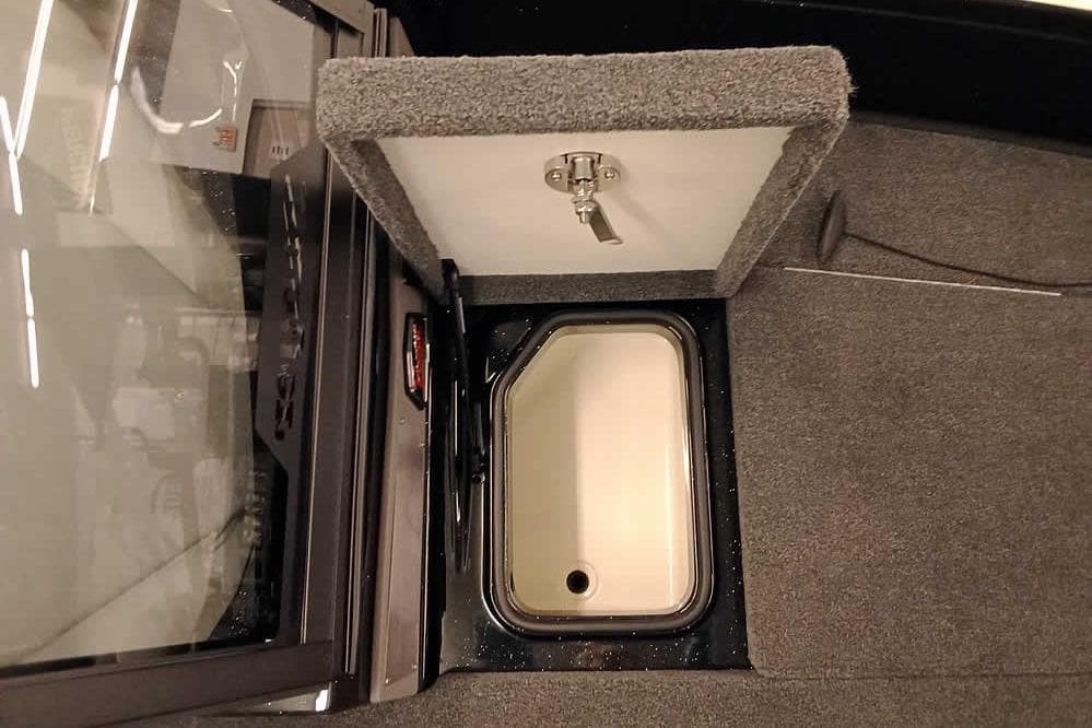 2026 Ranger 620xFS Pro boat storage compartment with open lid and carpeted interior.