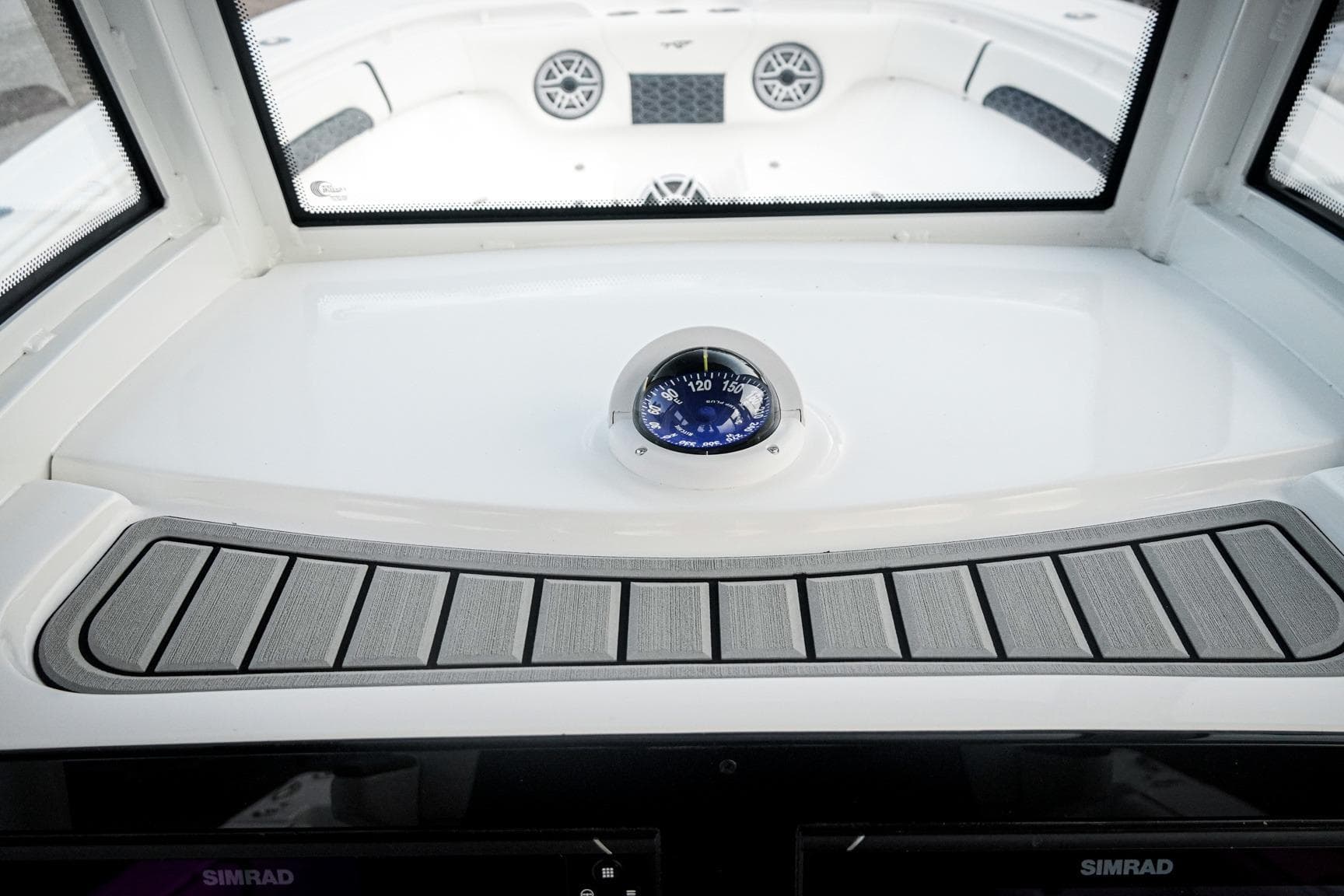 2026 Tidewater 282 CC Adventure boat dashboard with compass and Simrad display.