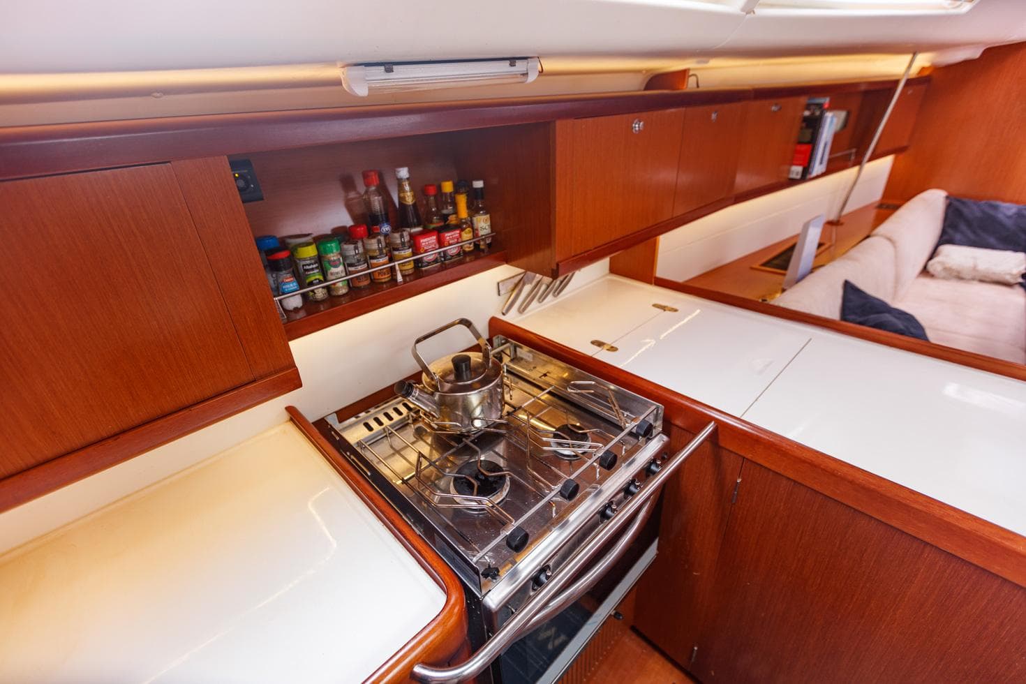 Galley kitchen in 2009 Beneteau Oceanis 46 yacht with stove and spice rack.