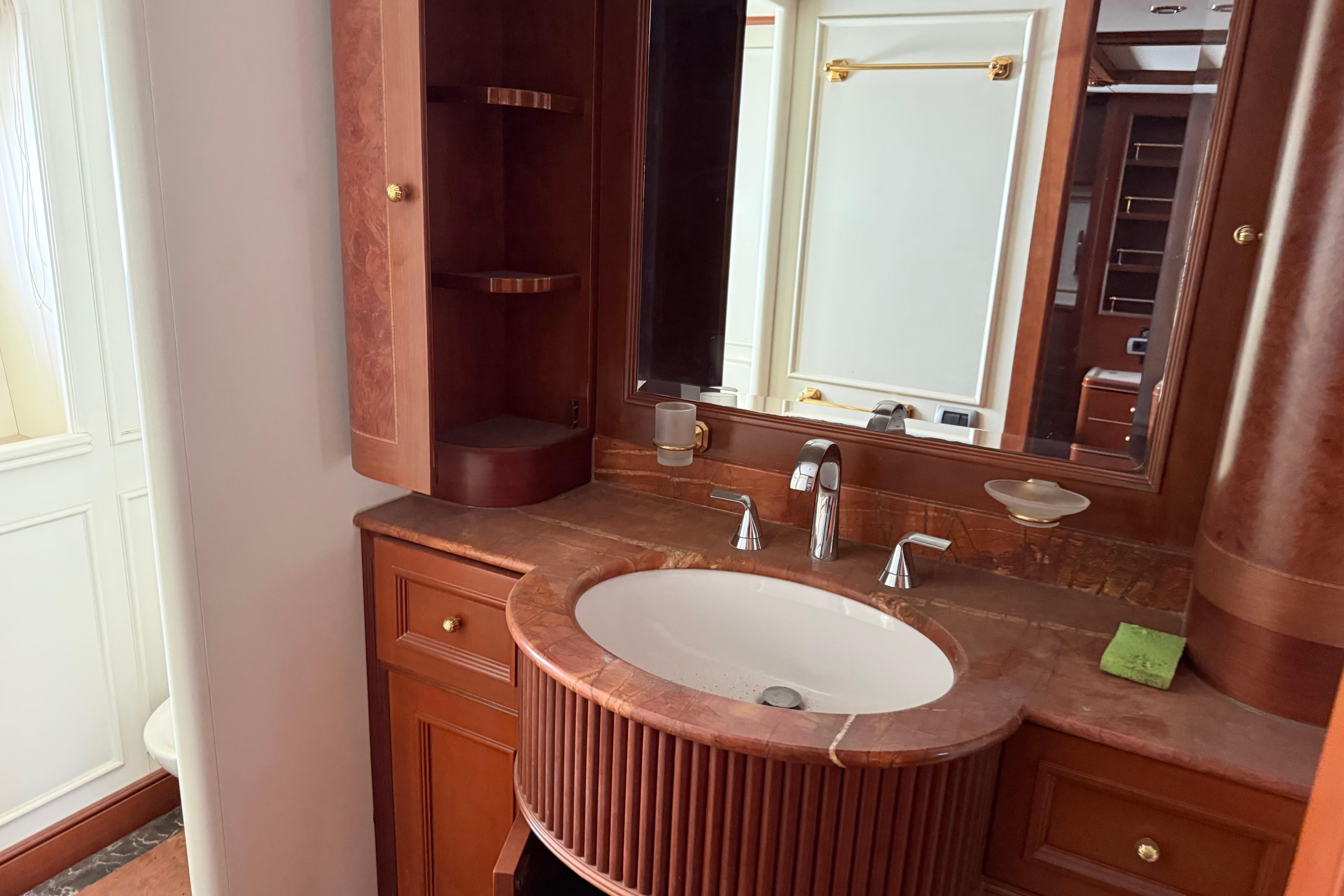 Luxurious bathroom on 2003 Benetti Classic 115 yacht with elegant wood and marble finishes.