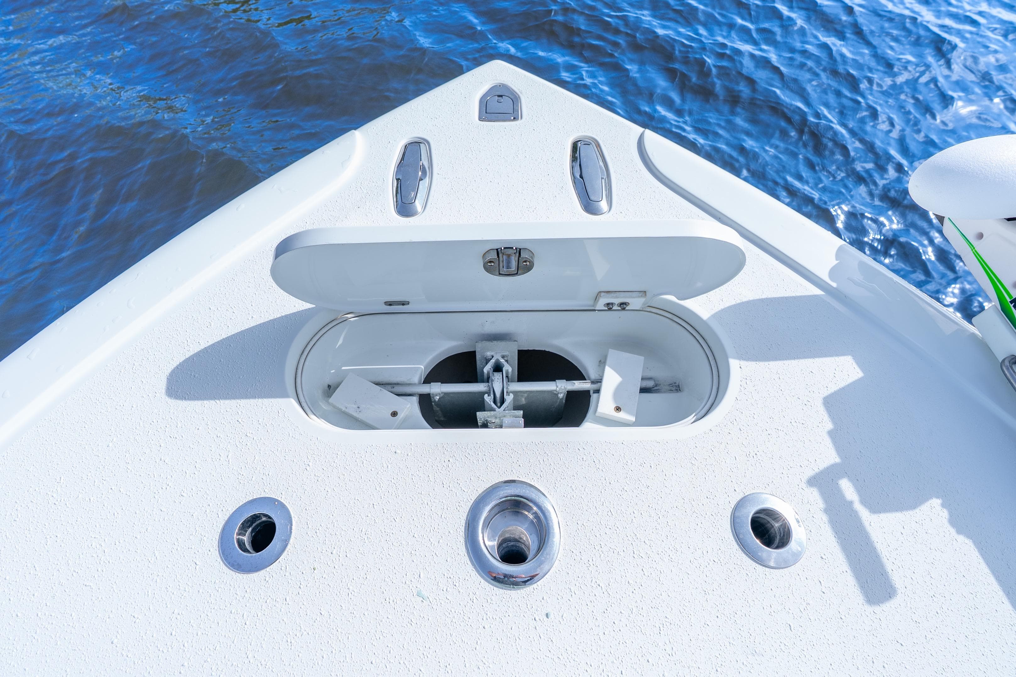 Bow of 2014 Yellowfin 32 Offshore boat with anchor compartment open.
