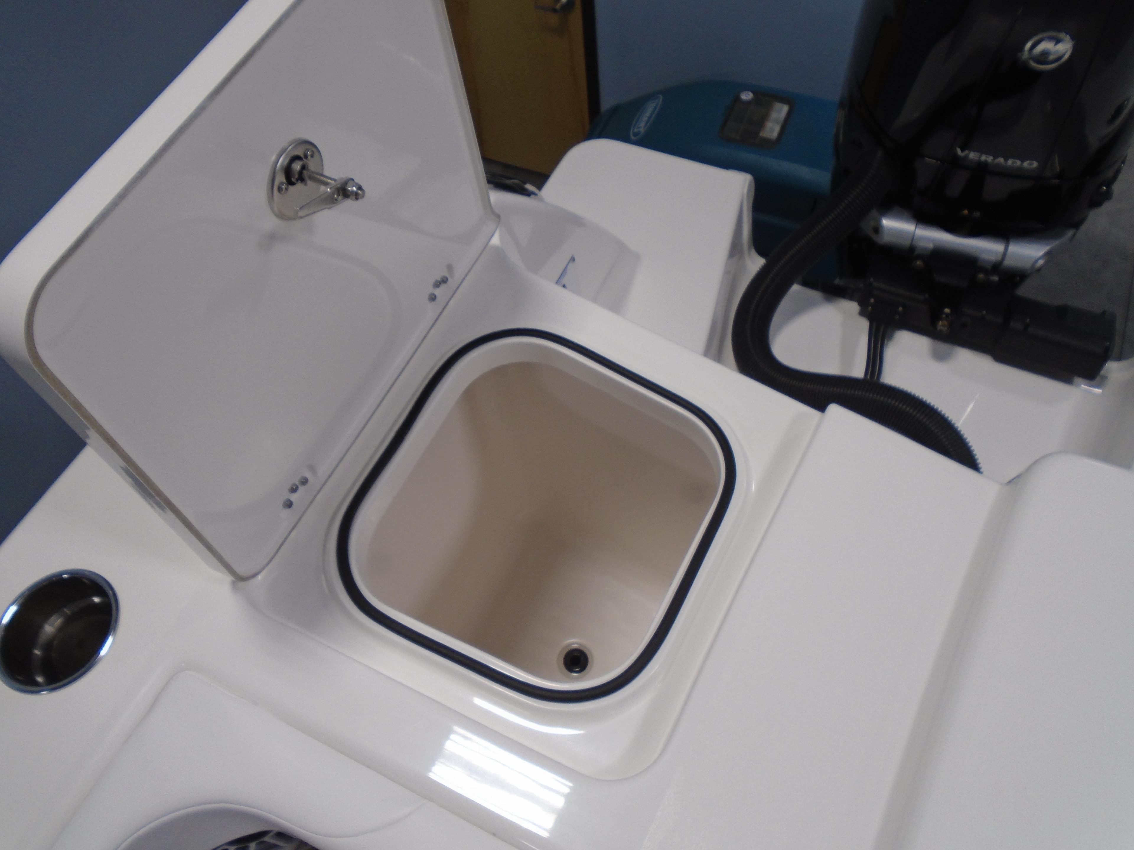 2026 Caymas 34 CT boat storage compartment with open lid and visible engine components.