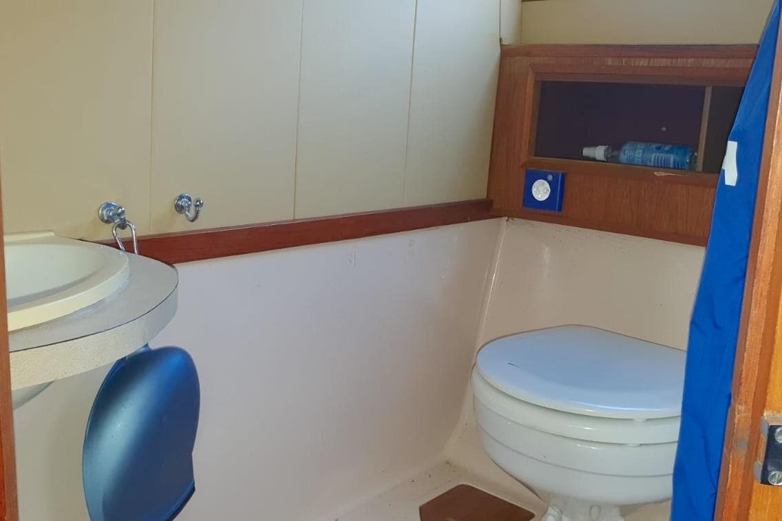 Bathroom interior of 1989 Fairey Spearfish MKIII boat with sink and toilet.