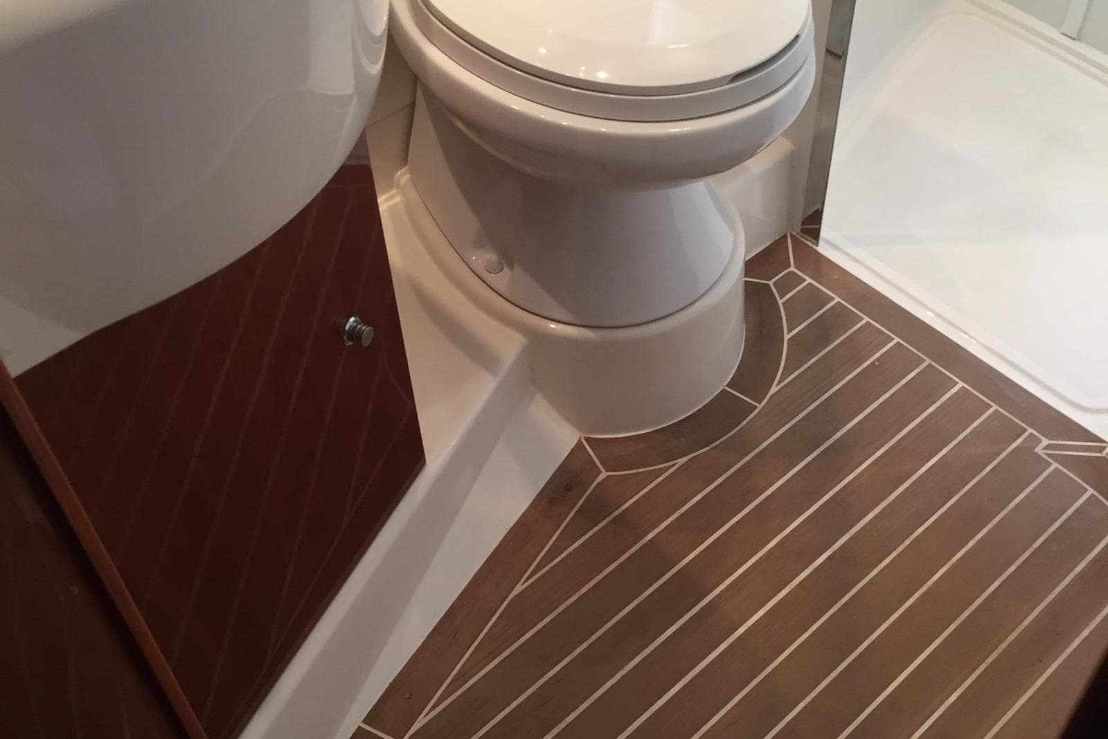 Bathroom interior of 2006 Princess V48 yacht with wood-patterned flooring.