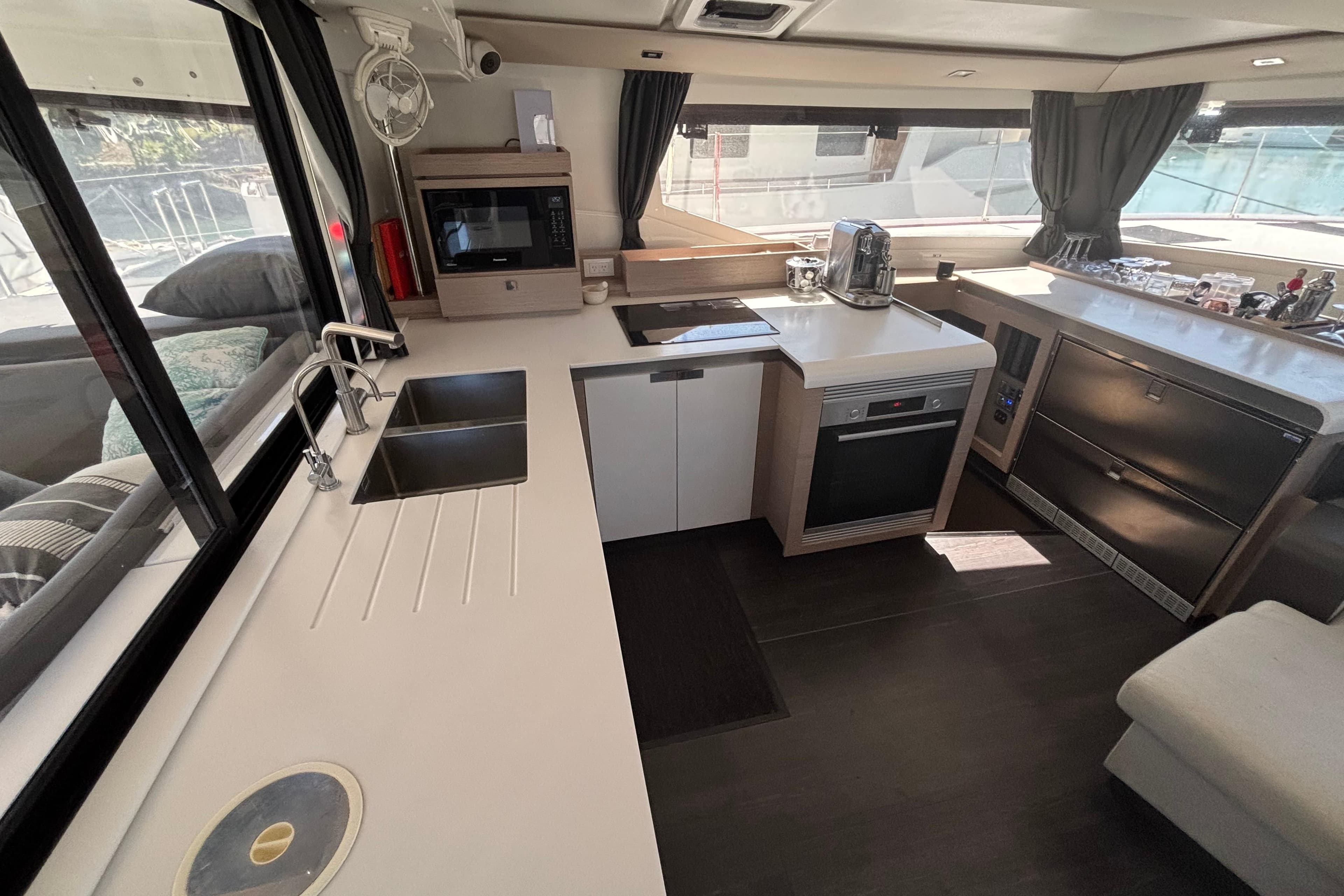Modern kitchen interior of 2022 Fountaine Pajot Tanna 47 yacht, featuring sleek appliances and ample counter space.