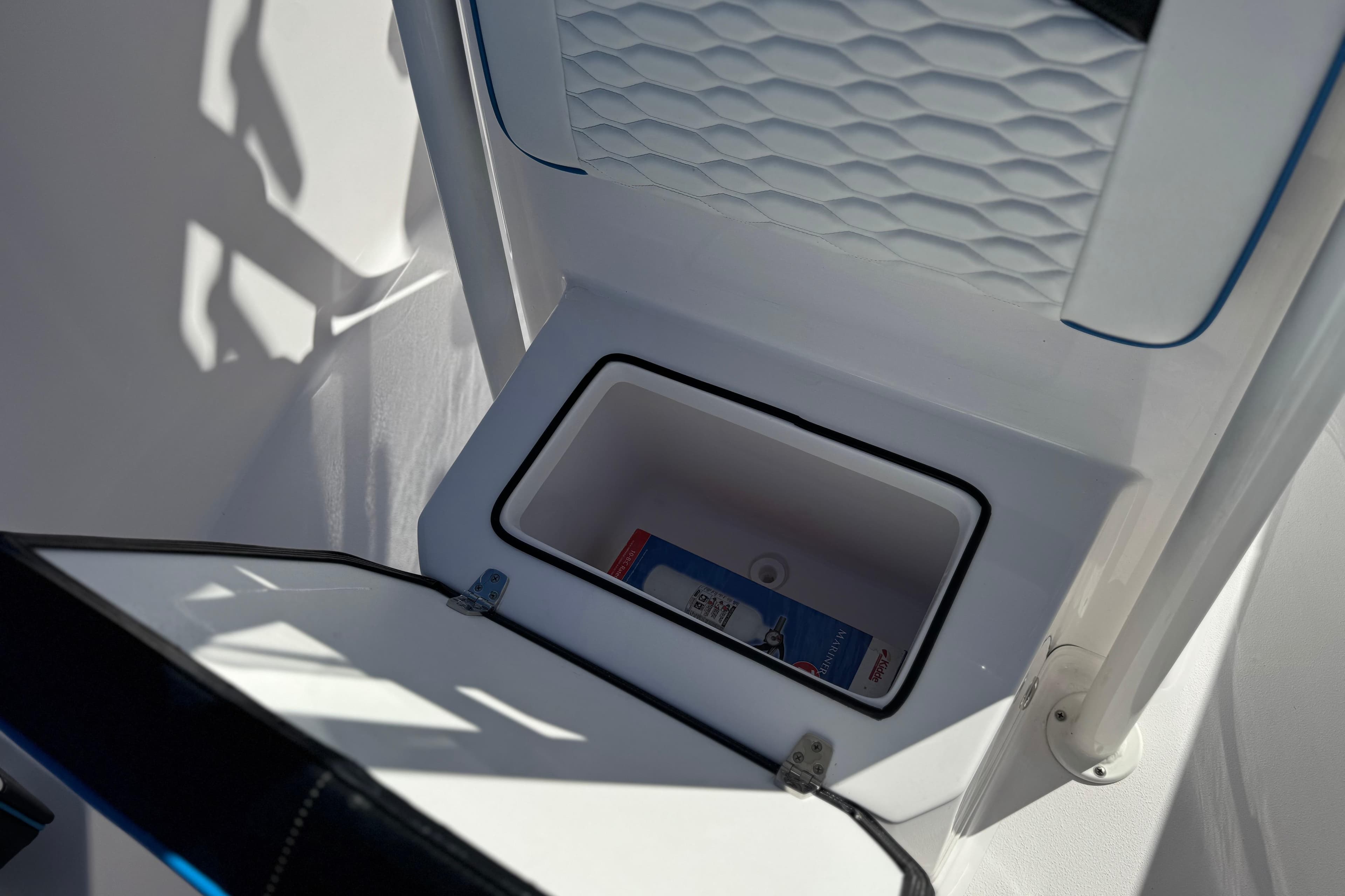 2024 Aquasport 2200 Center Console storage compartment with textured interior design.