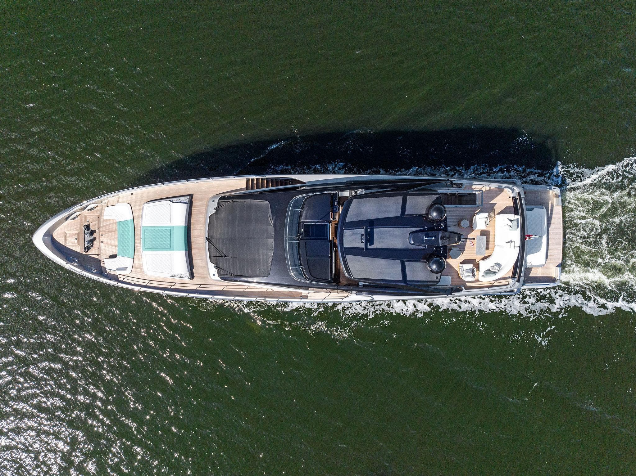 Aerial view of 2024 Riva 102 Corsaro Super yacht cruising on water.