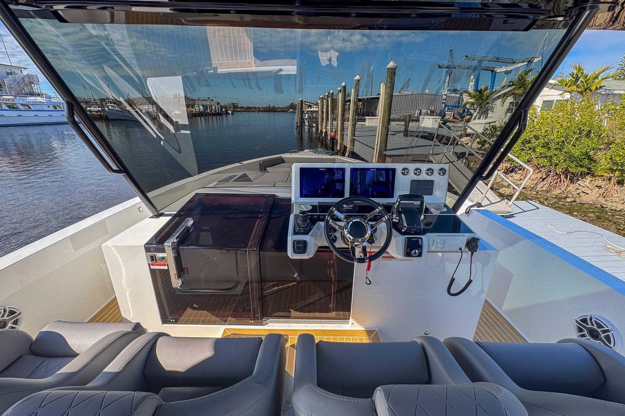 Helm of 2026 De Antonio Yachts D42, featuring modern controls and waterfront view.