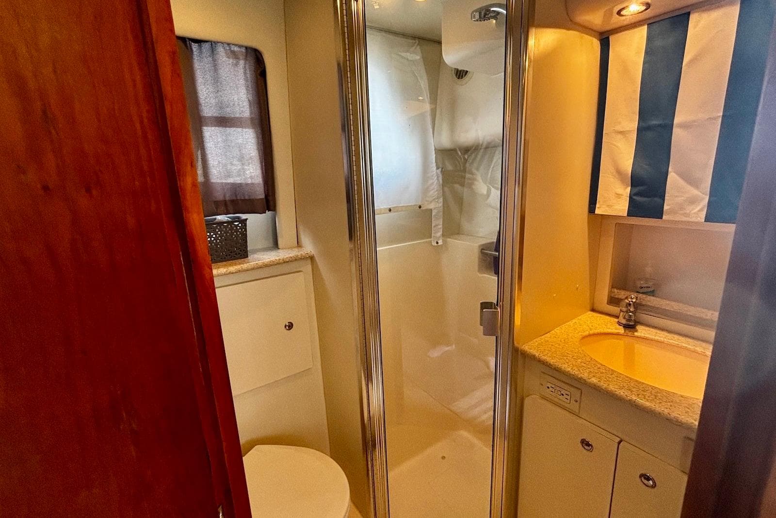 2001 Silverton 330 Sport Bridge bathroom with shower, sink, and toilet.