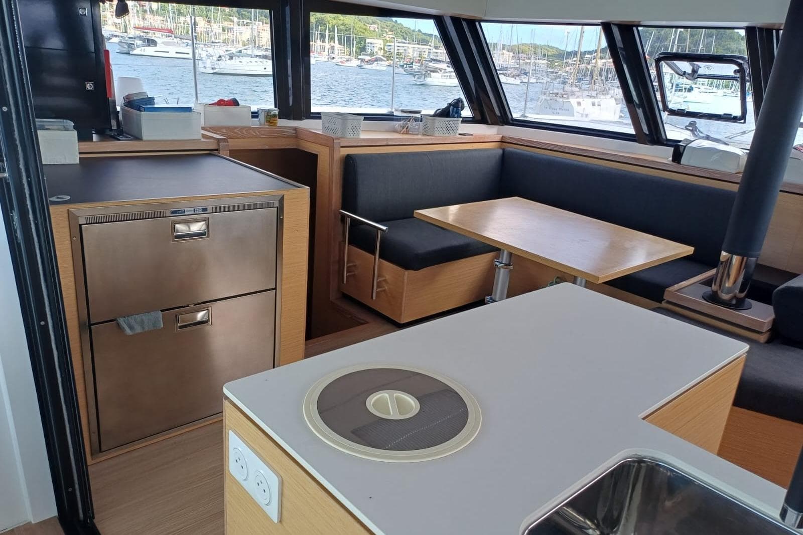 Modern interior of 2023 Nautitech 46 Open catamaran with dining area and kitchen.