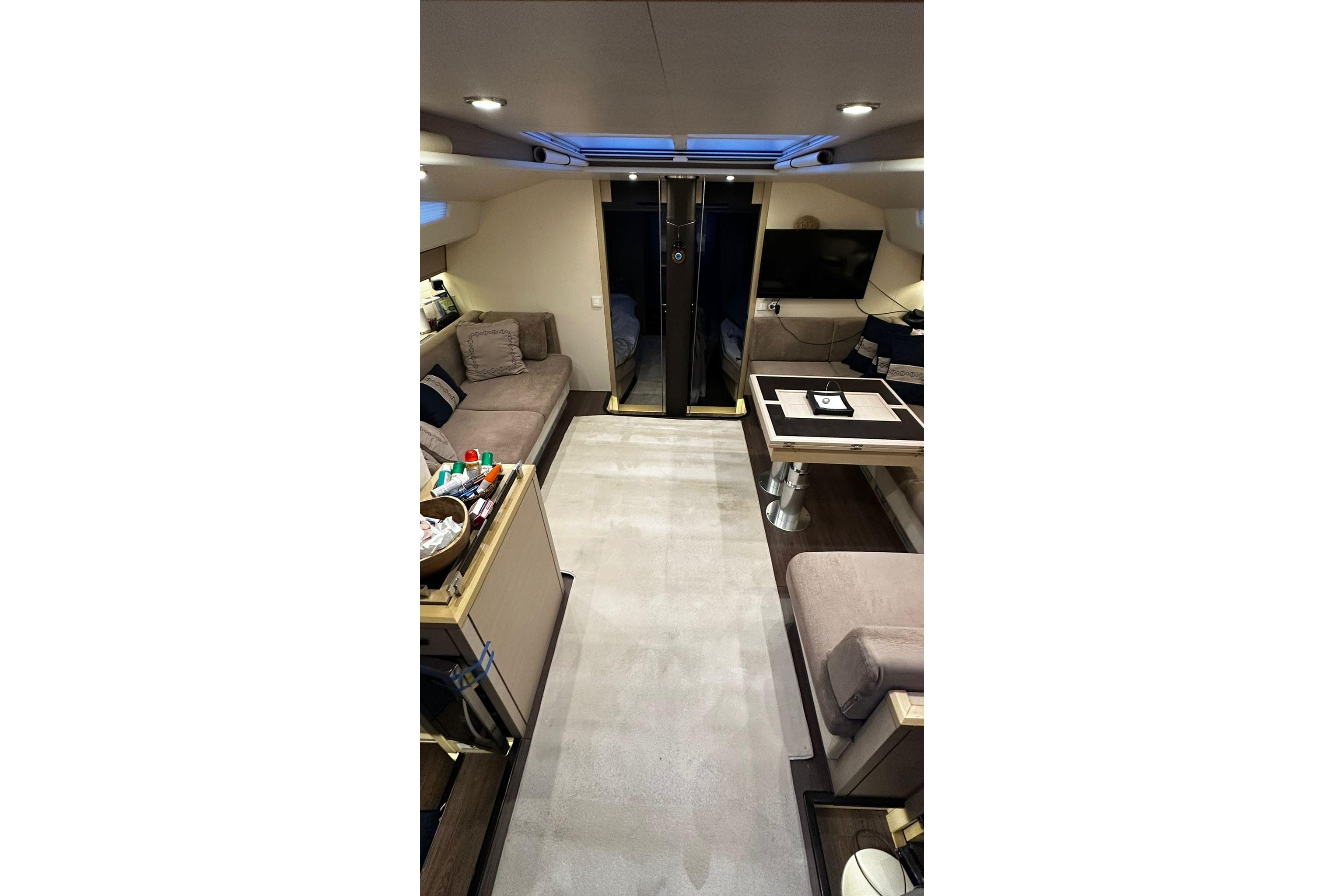 Luxurious interior of a 2020 Jeanneau 64 yacht, featuring elegant seating and modern amenities.