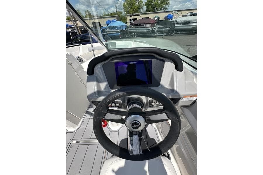 2023 Chaparral 23 Surf boat dashboard with steering wheel and digital display.