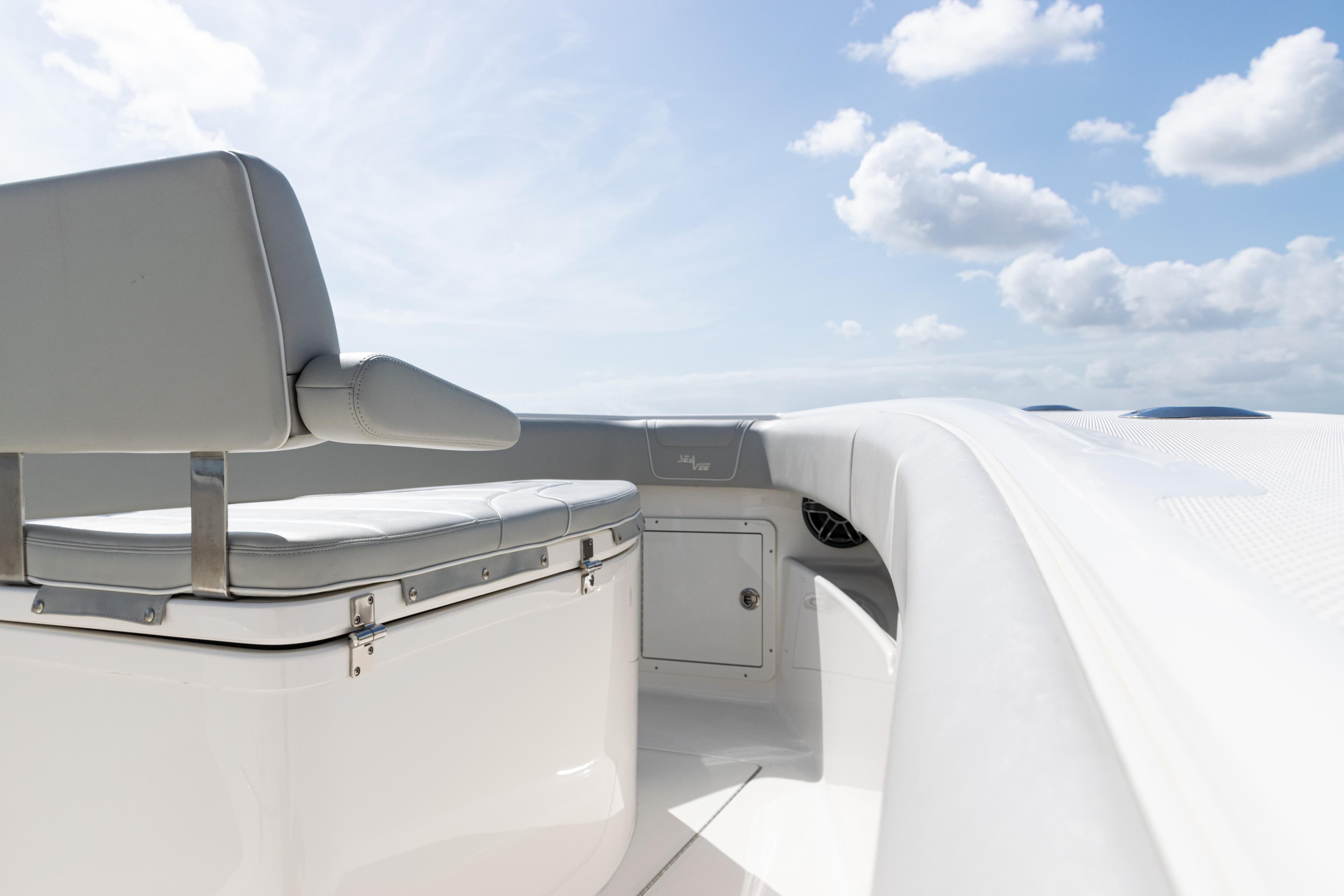 2024 SeaVee 290B boat interior with seating, under a clear blue sky.