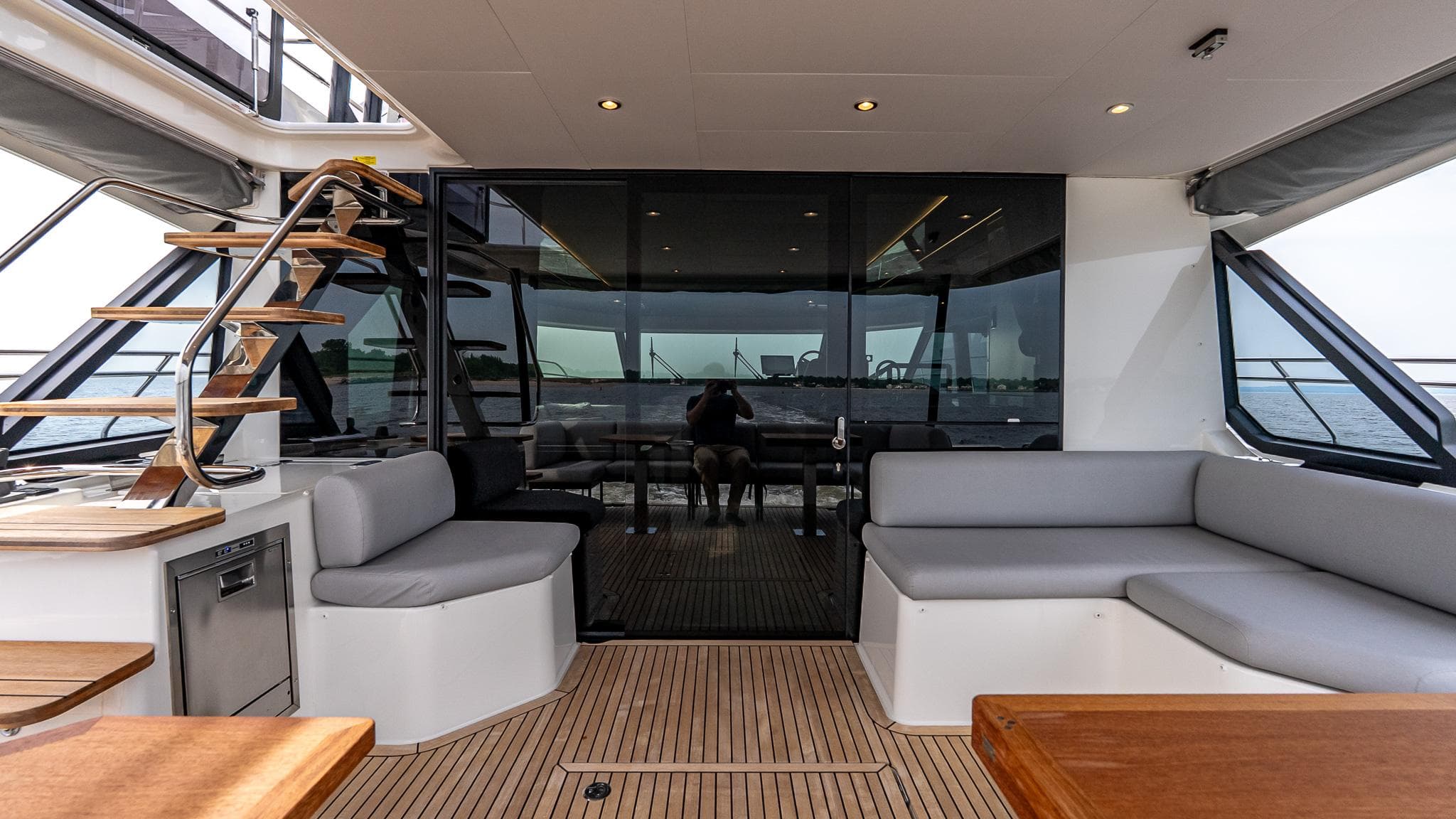 Luxurious 2026 Prestige M48 yacht interior with modern seating and elegant staircase.