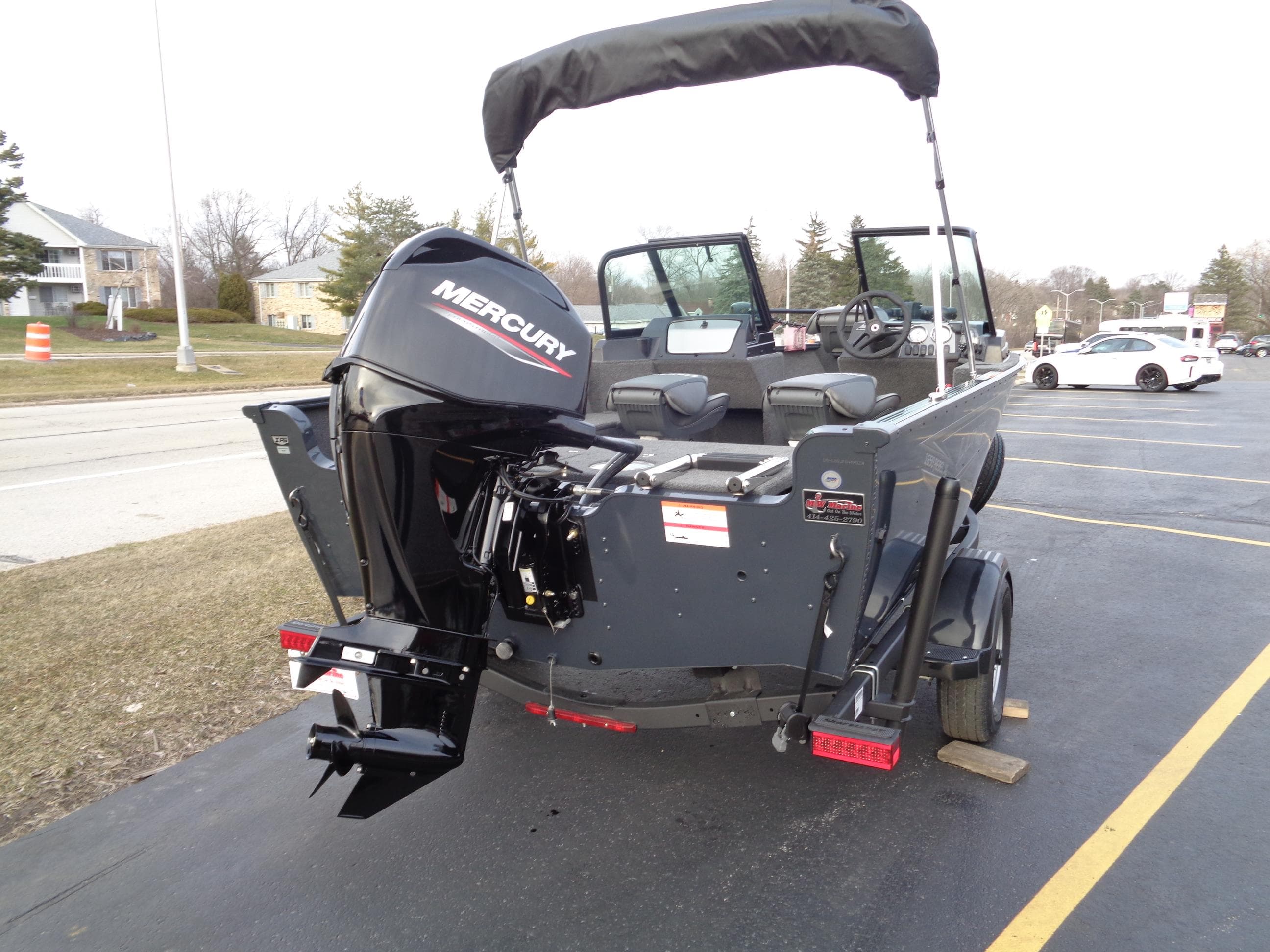 2024 Lund 1650 Rebel XL Sport boat with Mercury engine, parked on a trailer.