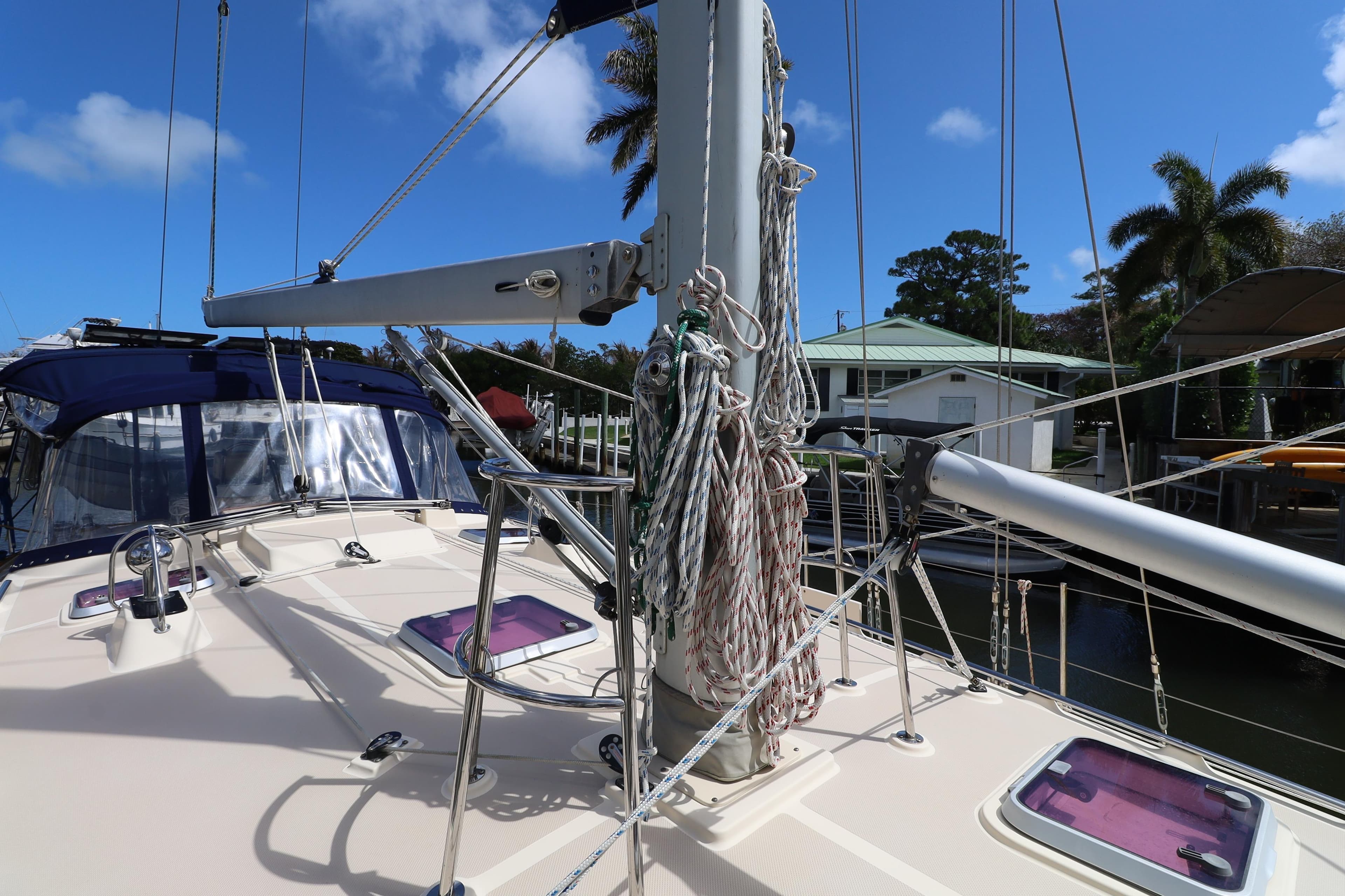 2006 Island Packet 440 sailboat deck with rigging and clear blue sky.
