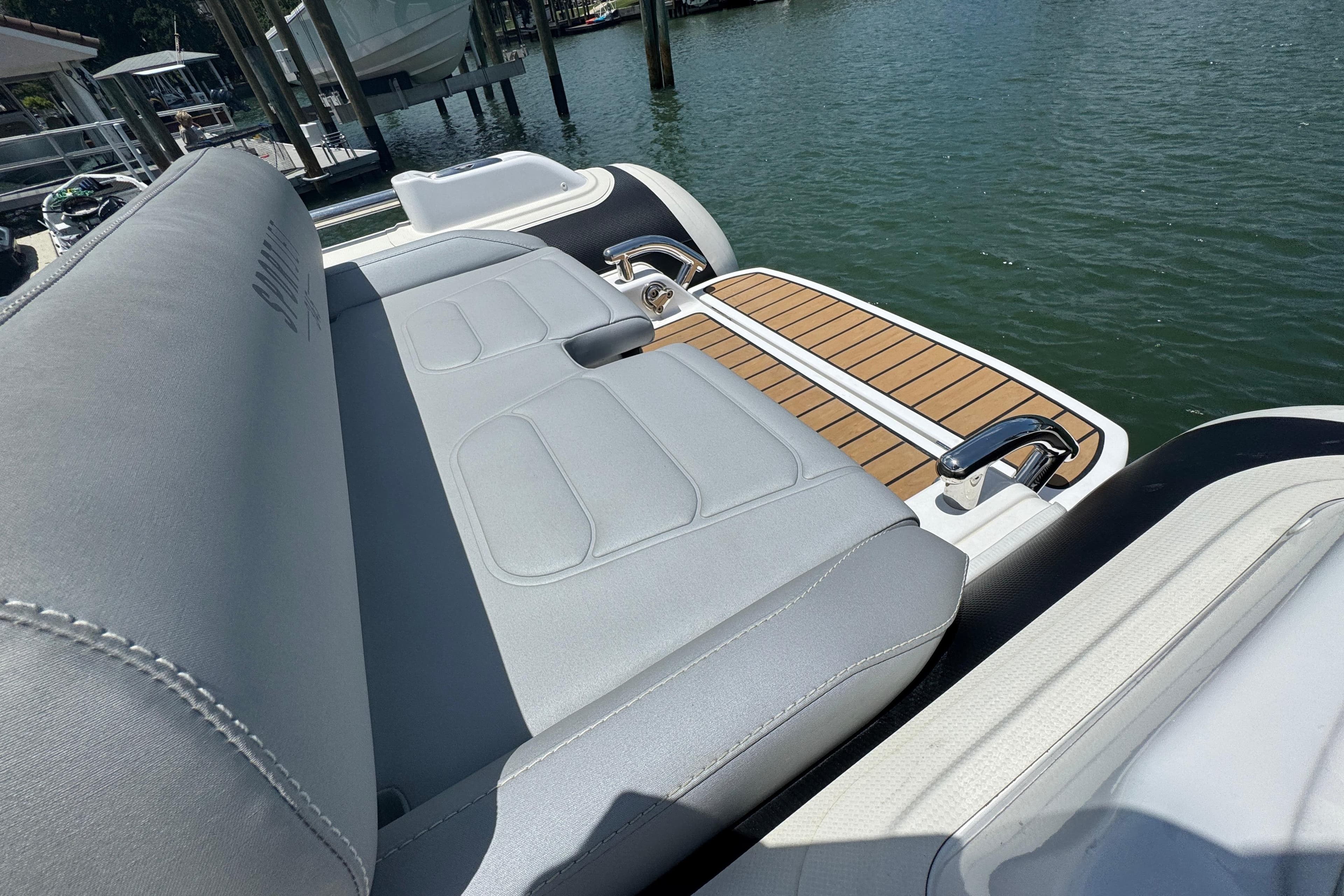 2025 Williams Jet Tenders Sportjet 345 with sleek seating and teak deck by the water.