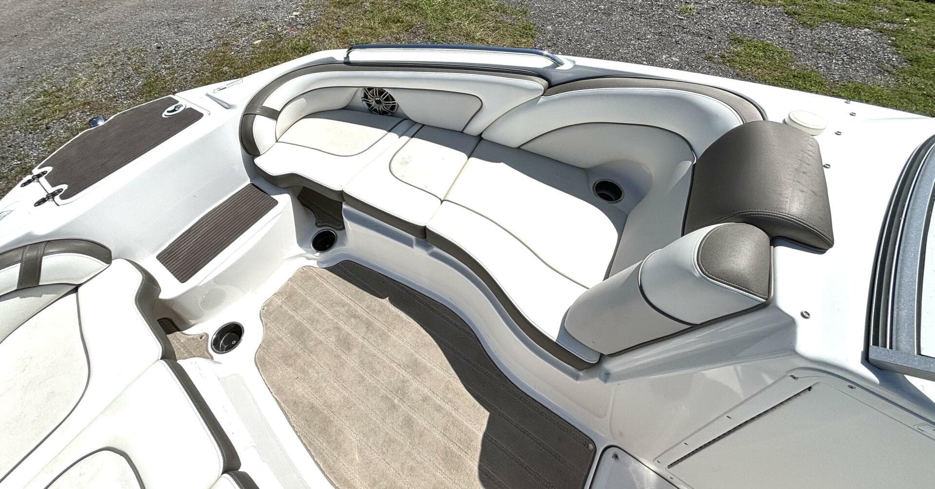 2013 Yamaha Boats 242 Limited S interior with white seating and cup holders.