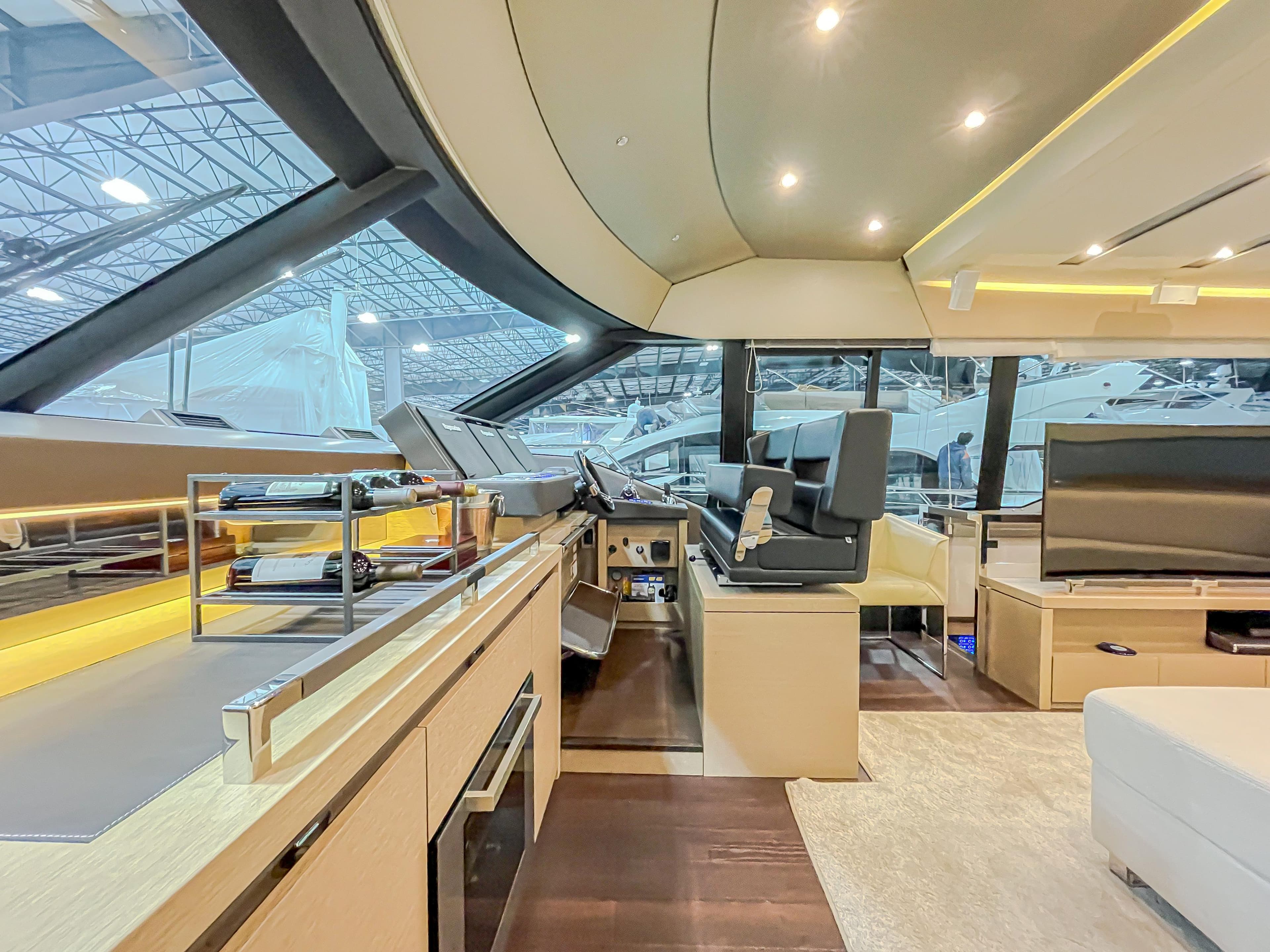 Luxurious interior of 2016 Prestige 680 Flybridge yacht with modern helm and seating area.