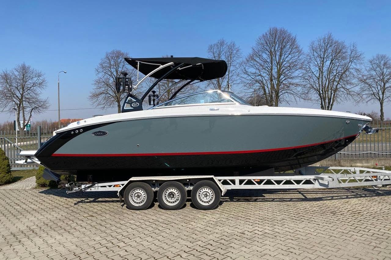 2020 Cobalt R7 Surf boat on trailer, parked outdoors on a sunny day.