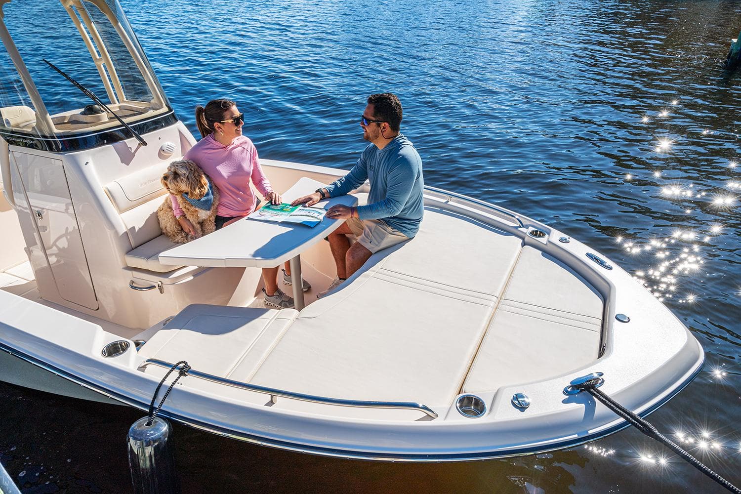 Manufacturer Provided Image: Grady-White 231 Coastal Explorer 2026 on water with passengers and dog.