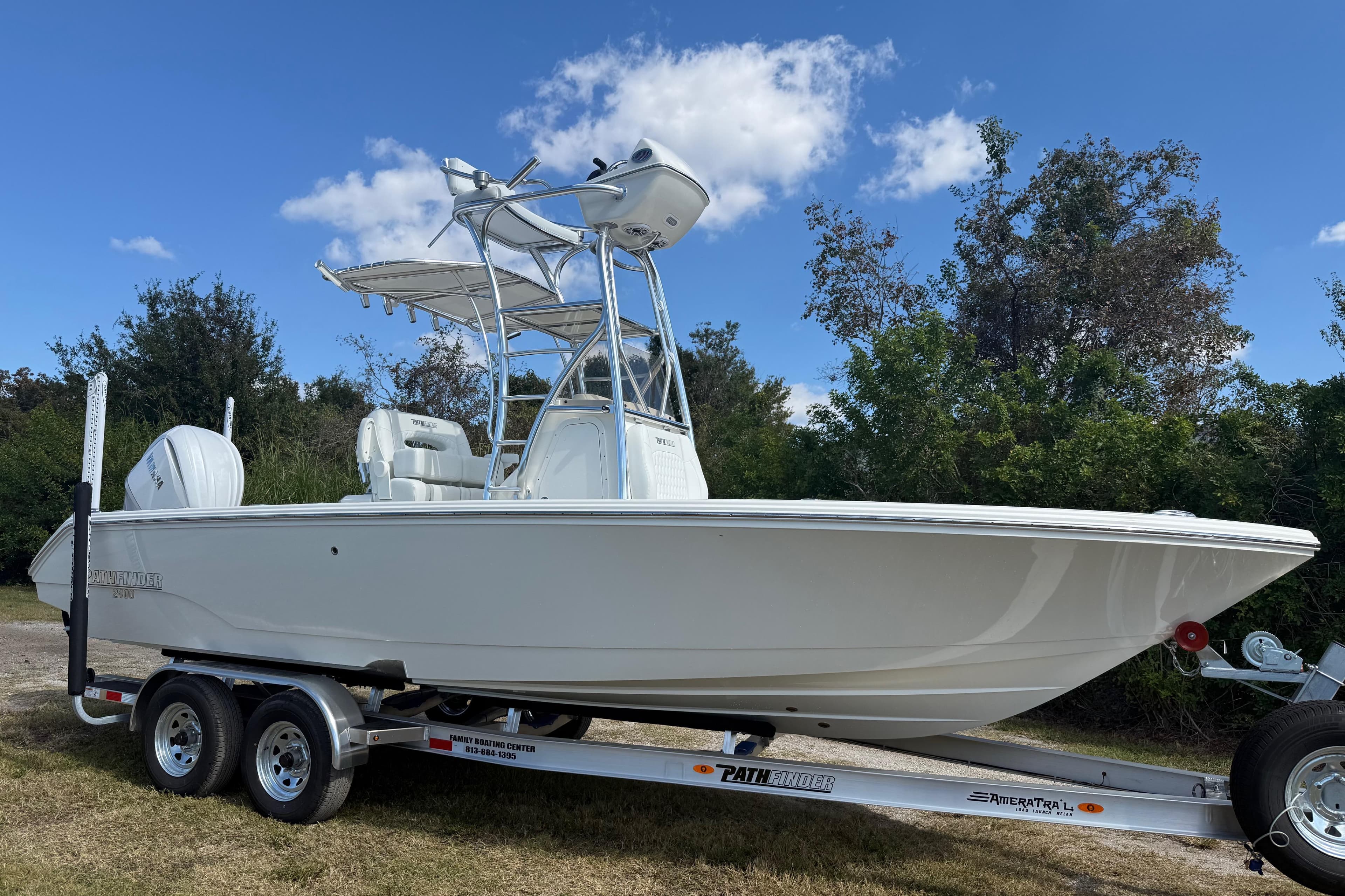2026 Pathfinder 2400 Open boat on trailer, set against a clear sky and greenery.