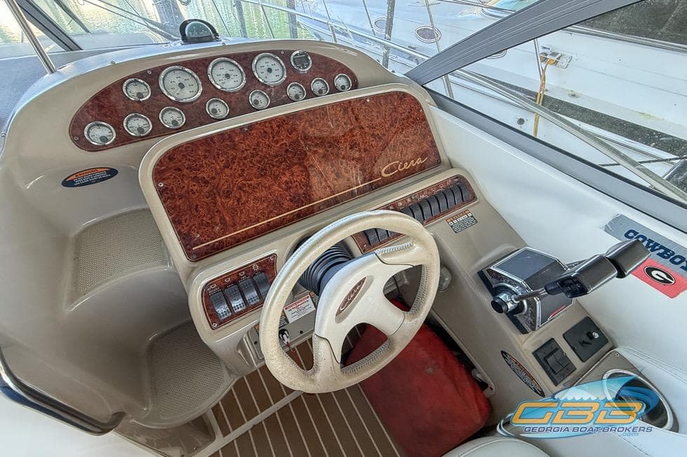 2002 Bayliner 3055 Ciera helm with woodgrain dashboard and steering wheel.