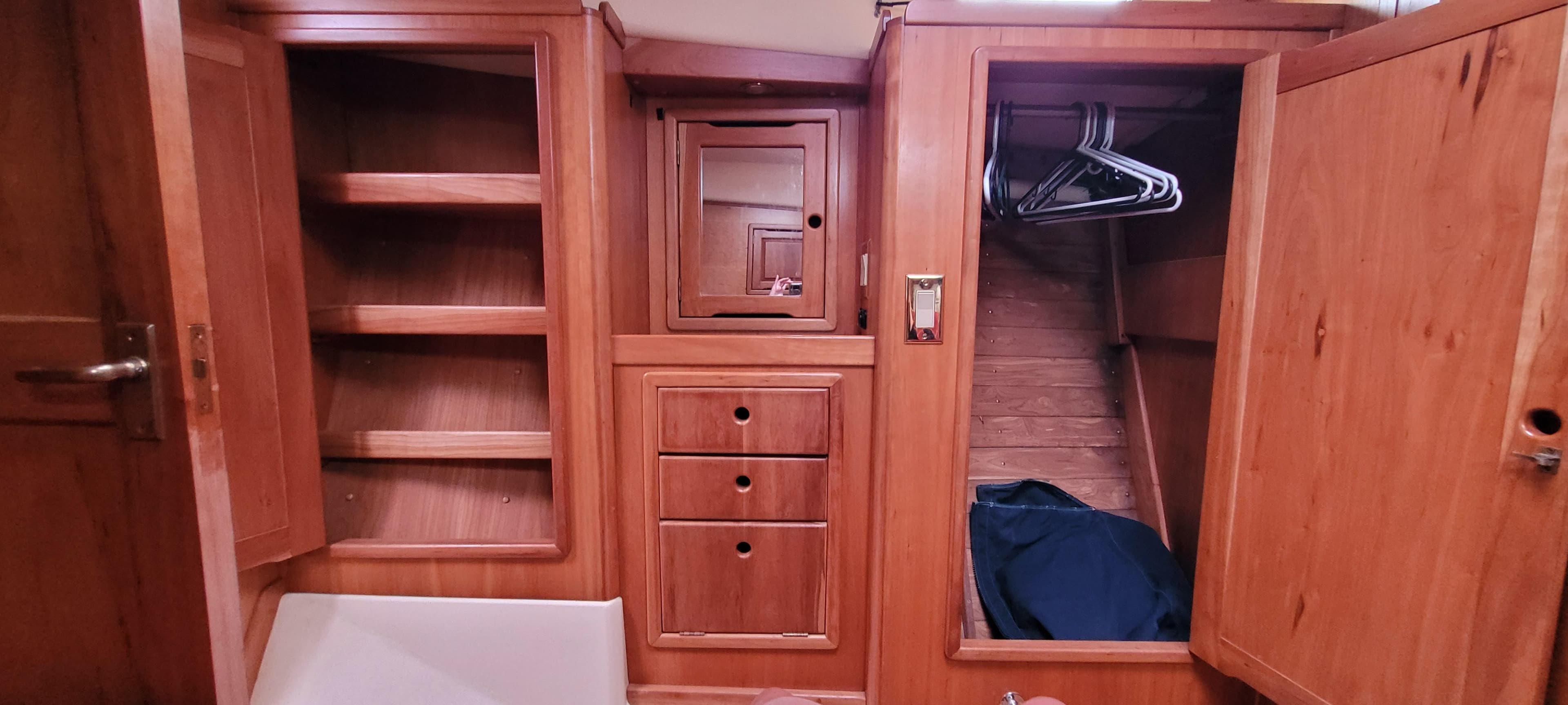 Wooden interior storage cabinets and closet in a 1997 Saga 43 boat.