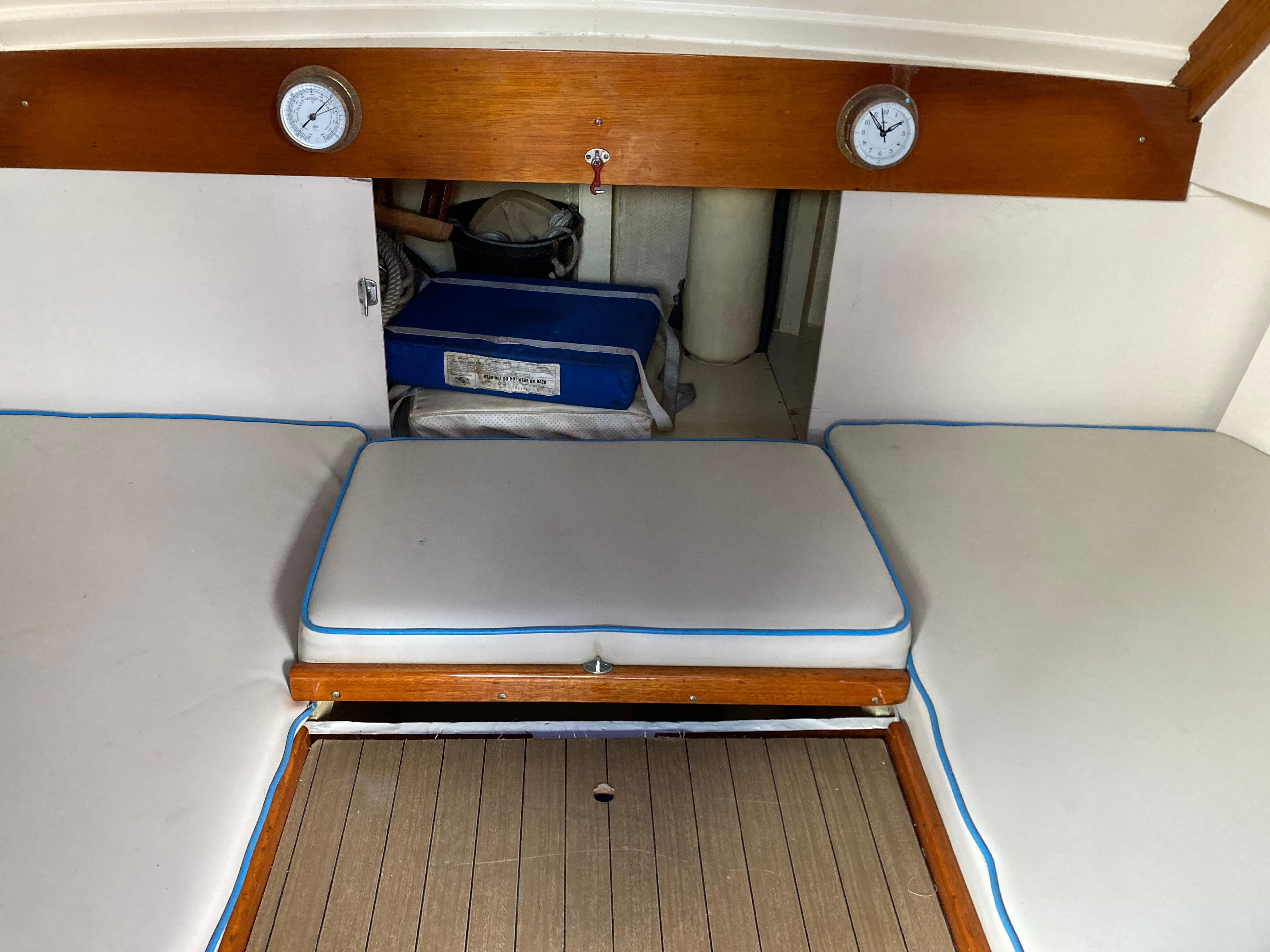 Interior of a 1963 Sumnercraft 31 Motor Sailer with cushioned seating and wooden accents.