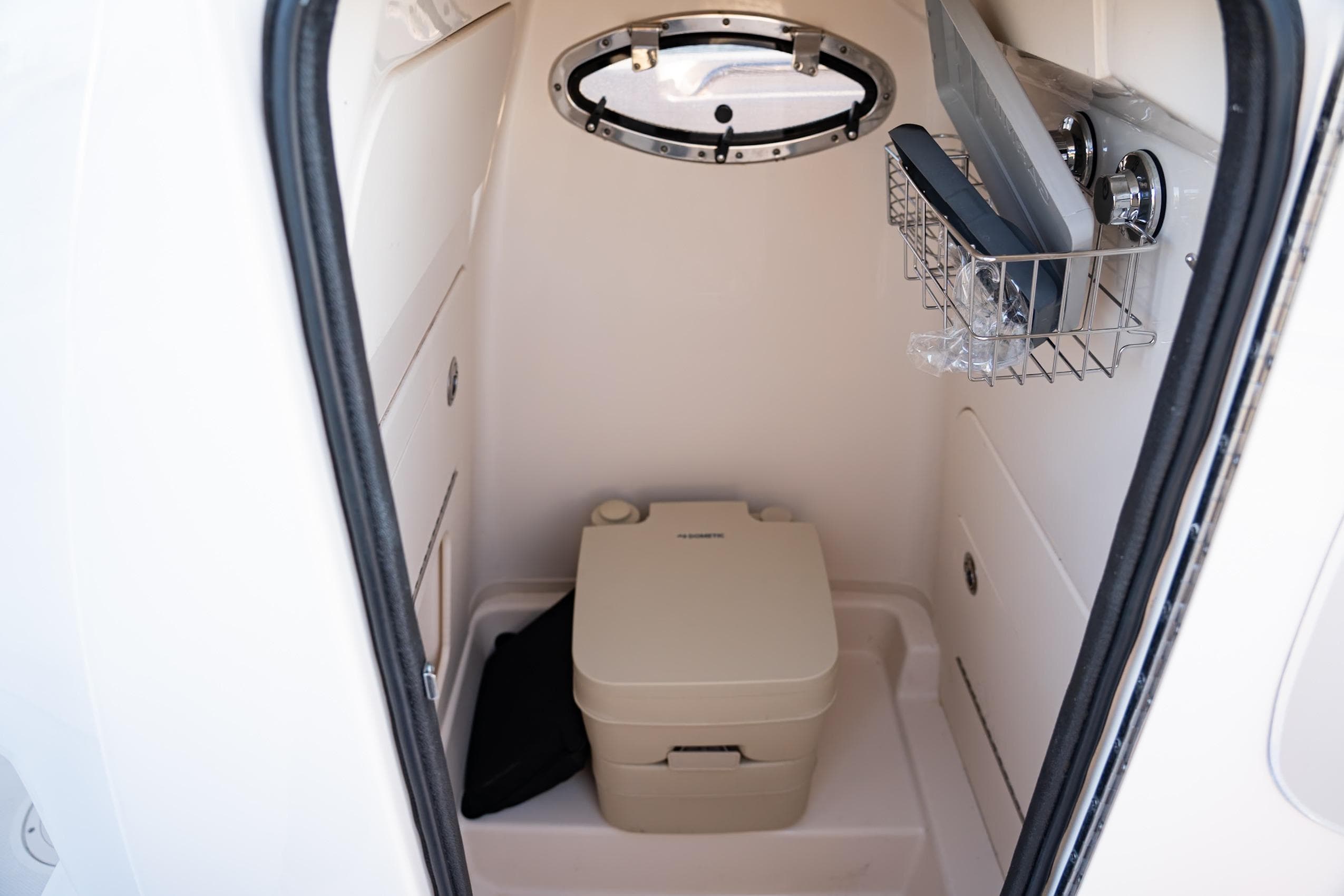 2018 Grady-White Fisherman 236 boat interior with compact marine toilet.