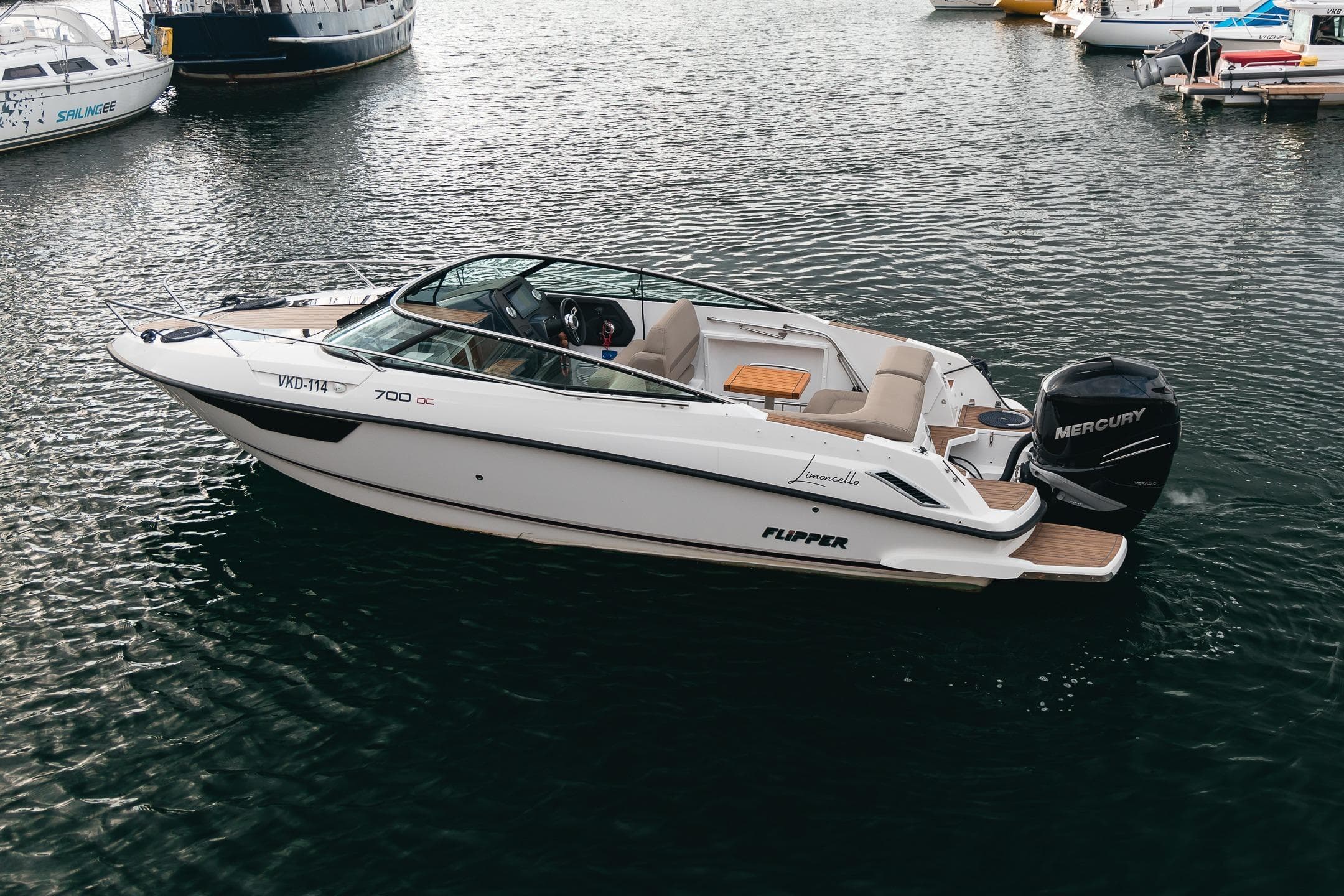 2019 Flipper 700DC boat with Mercury engine docked in marina.