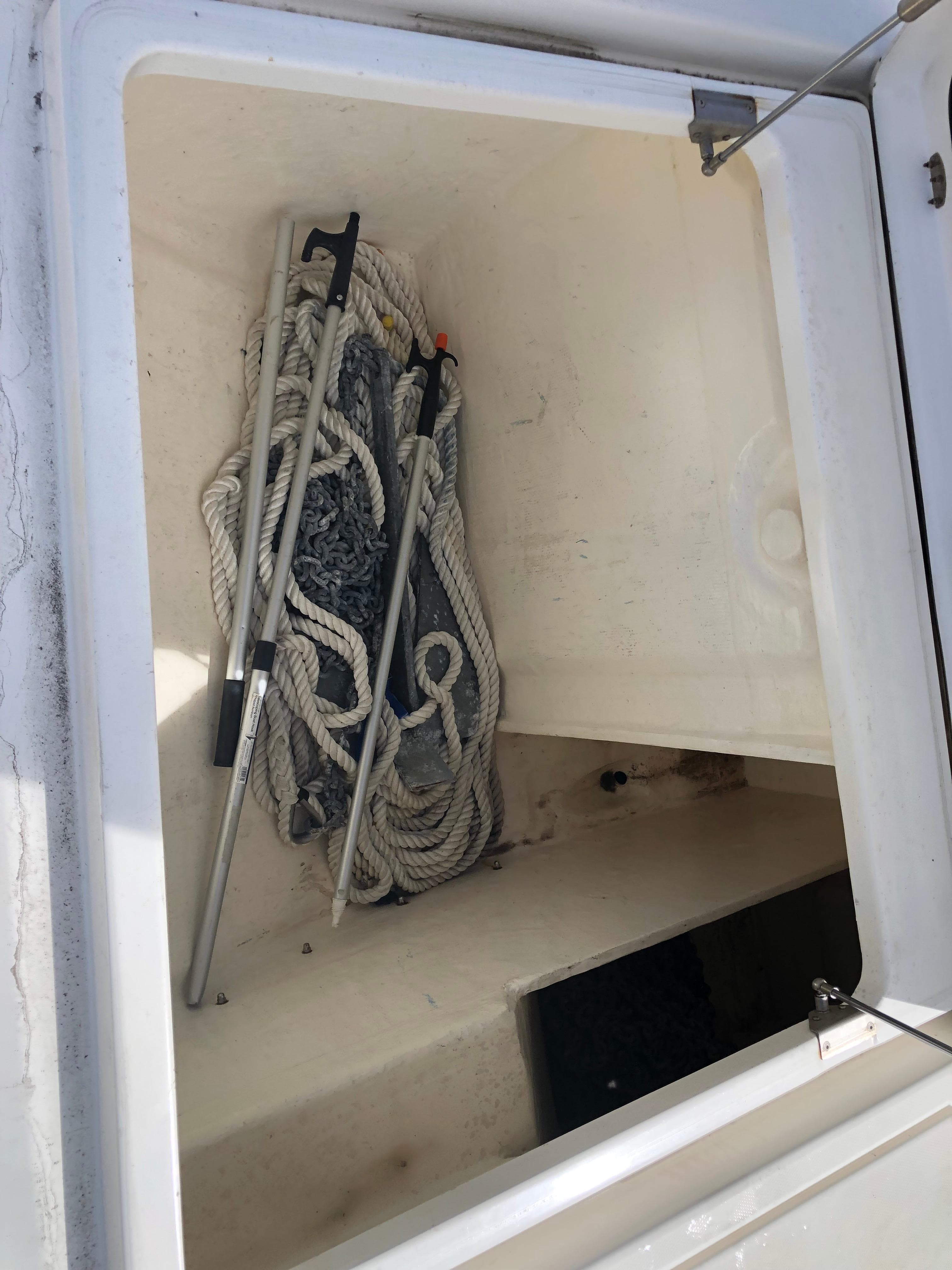 Storage compartment on a 2020 Leopard 50 yacht with ropes and poles.