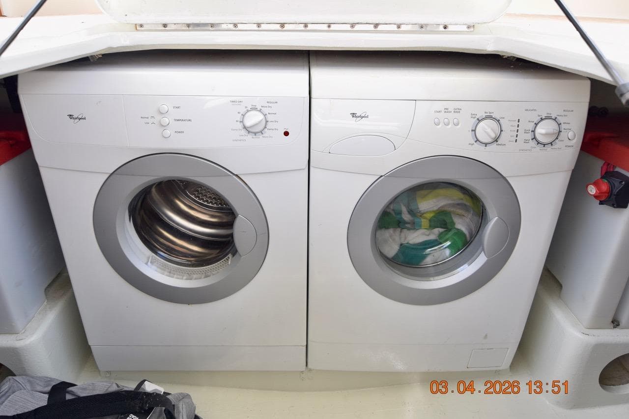 Laundry area with Whirlpool washer and dryer on 1976 Hatteras 48 Long Range Cruiser.