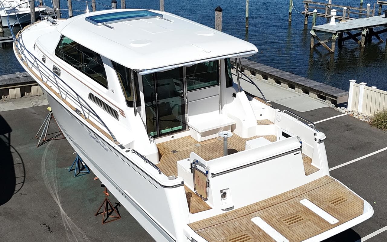 2026 Sabre 45 Salon Express yacht docked, showcasing sleek design and spacious deck.