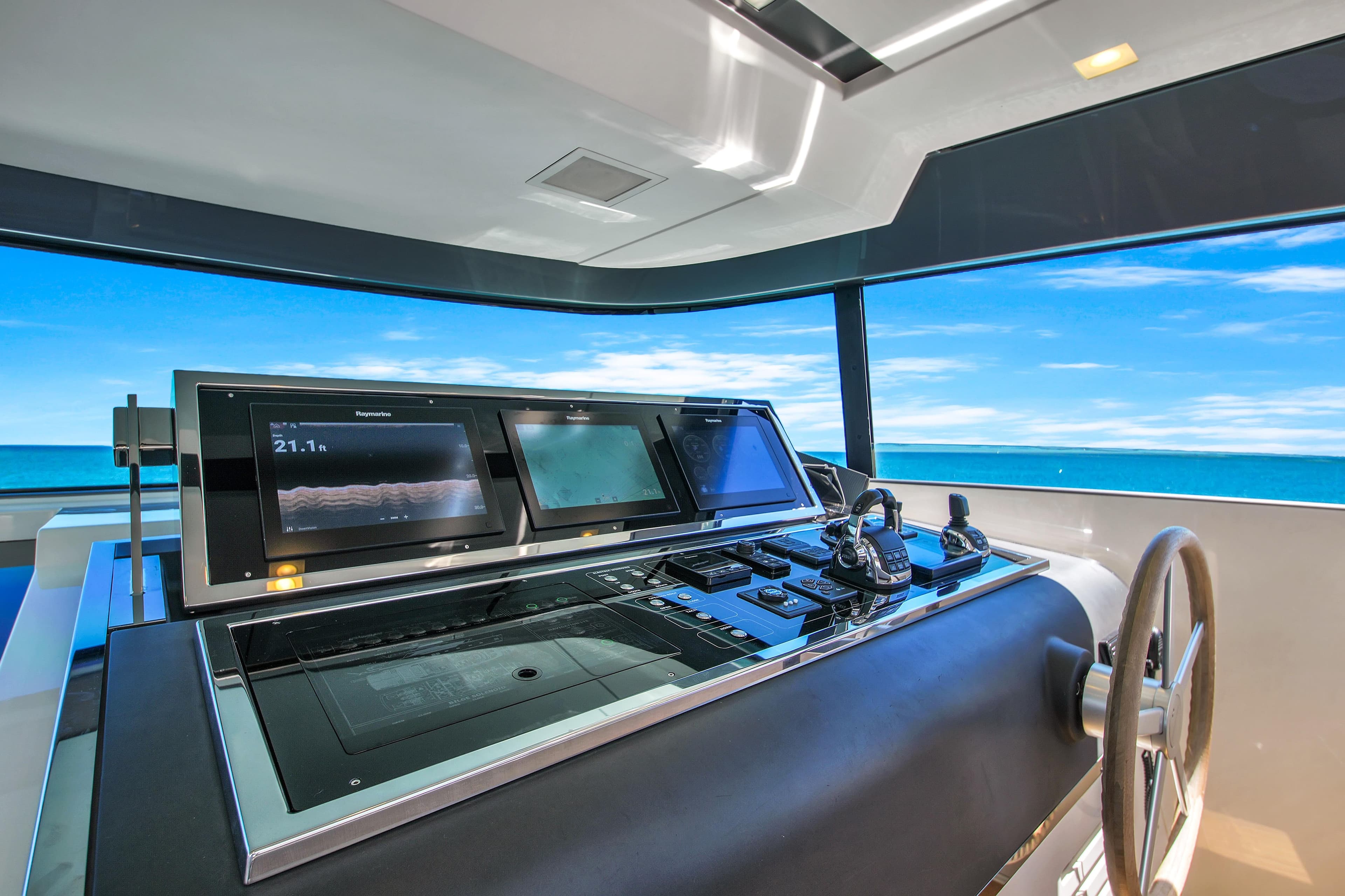 Helm of 2019 Sanlorenzo 90 yacht with advanced navigation systems and ocean view.