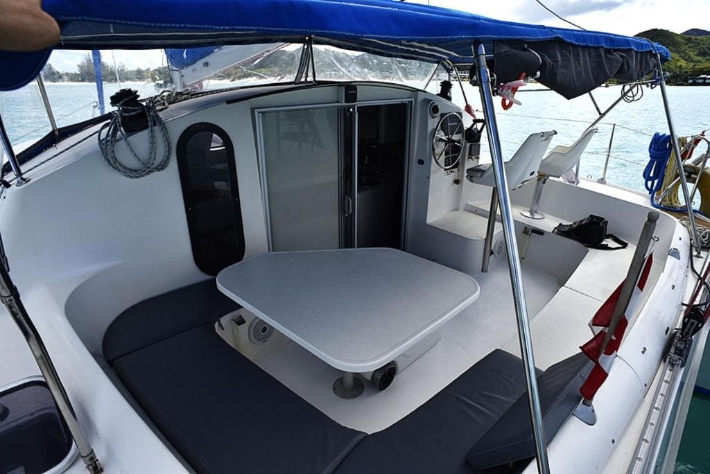 1997 Fountaine Pajot Athena 38 catamaran with spacious cockpit and seating area.