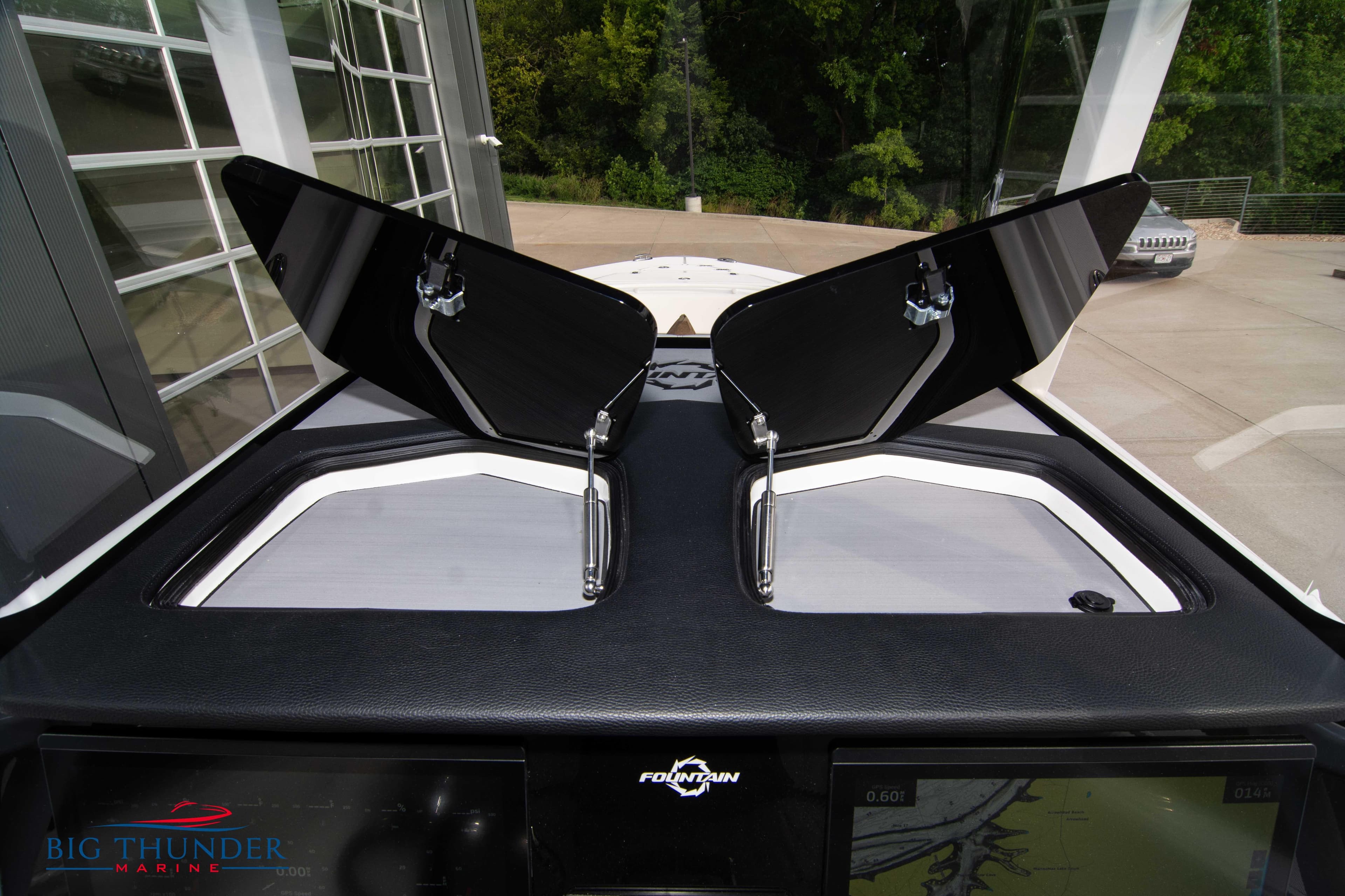 2023 Fountain 34 CC boat dashboard with open hatches, showcasing sleek design and functionality.