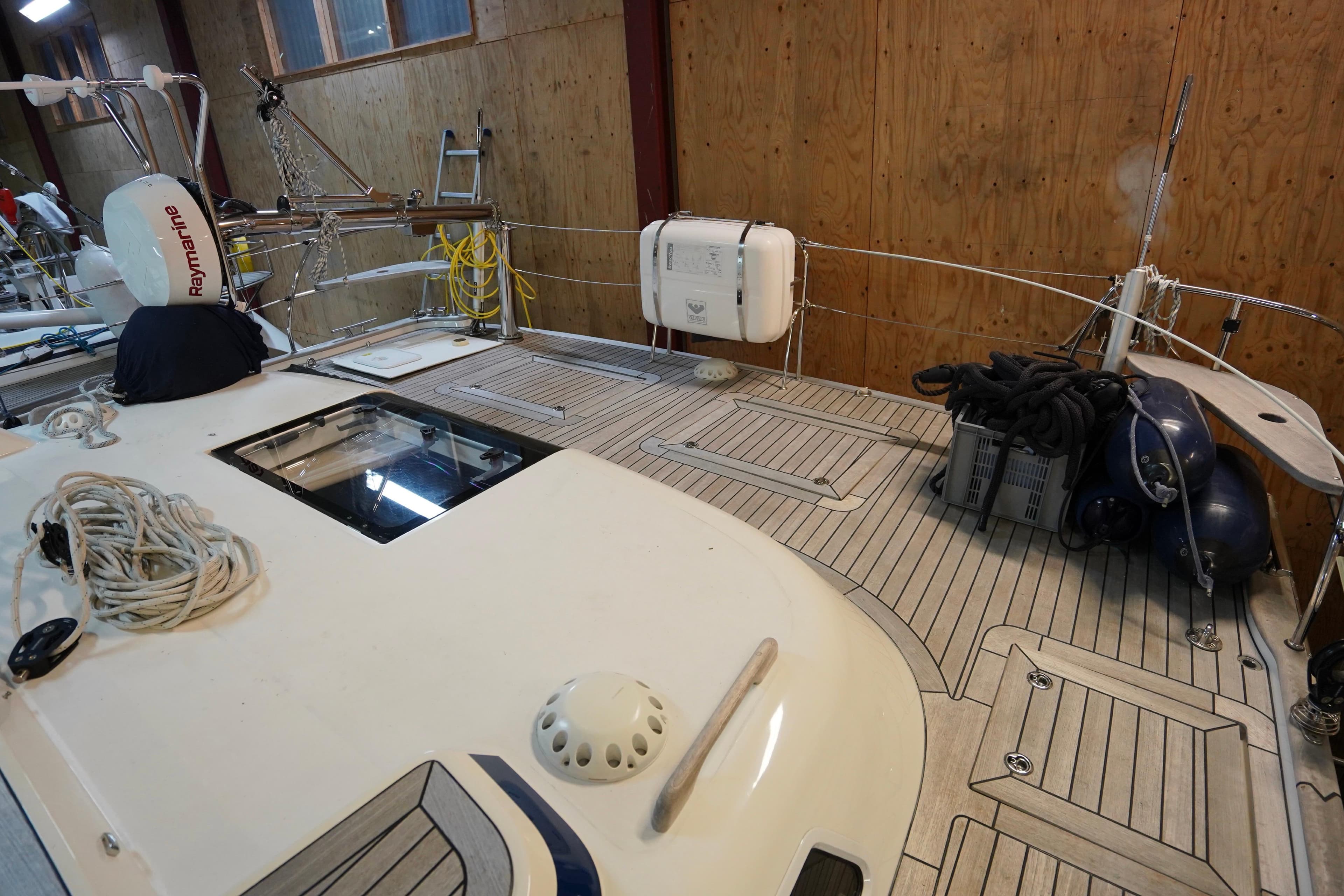 2020 Hallberg-Rassy 57 yacht deck with equipment and storage in a wooden interior setting.