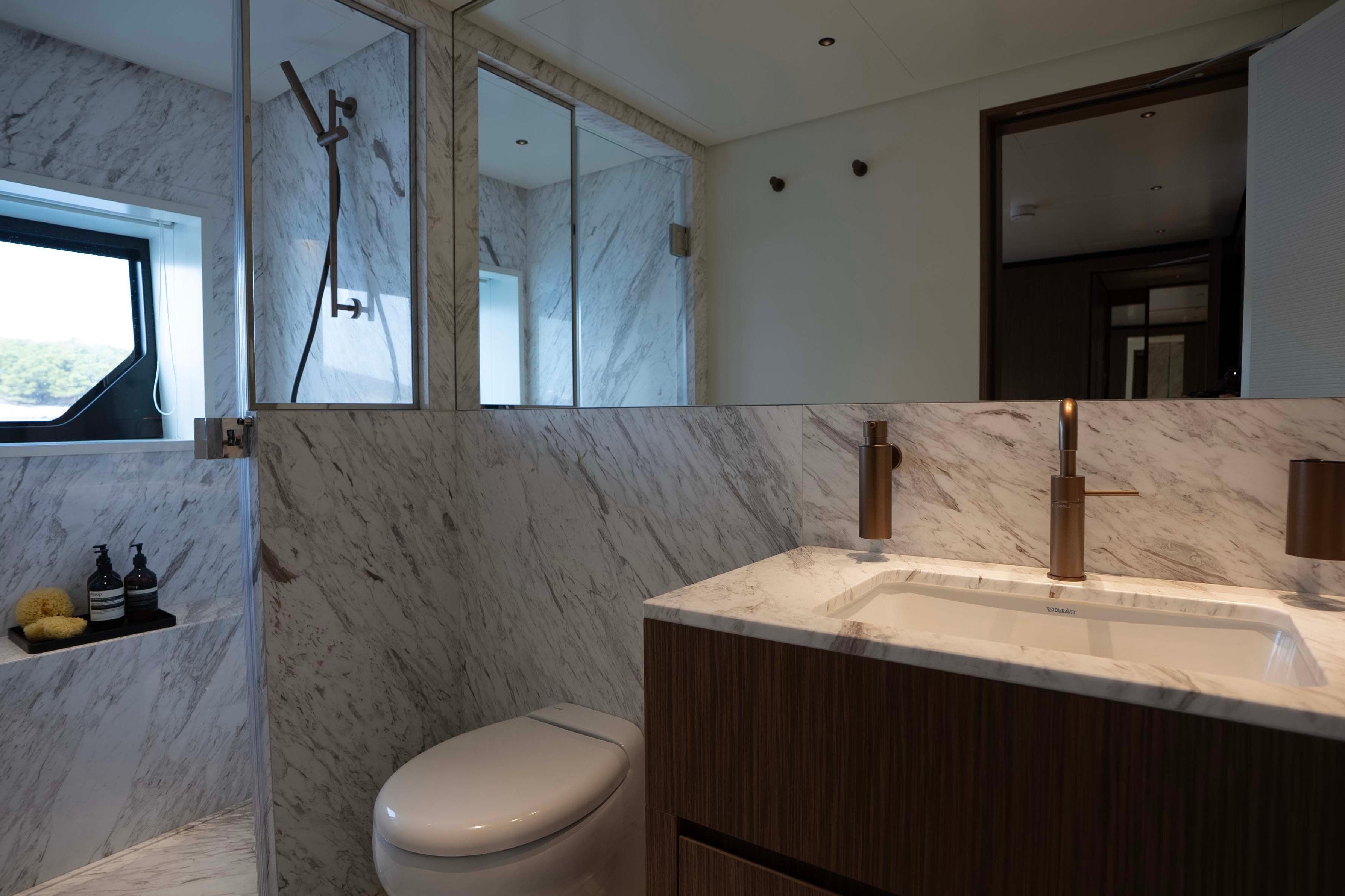 Luxurious marble bathroom in 2025 Alpha 100 Squalo Co Ownership yacht.