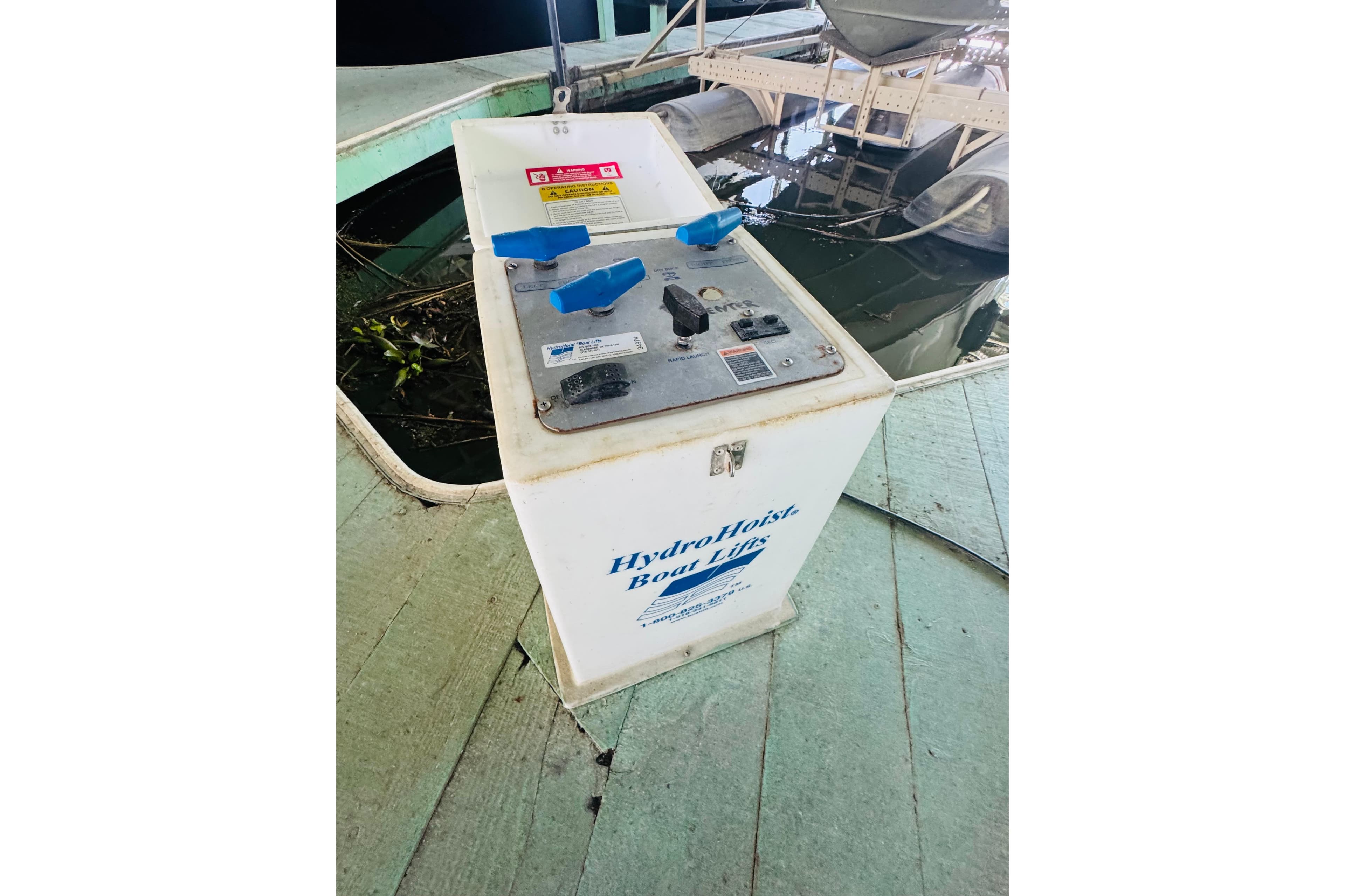 Control panel for HydroHoist boat lift near water, associated with 2000 Sea Ray 290 Sundancer.