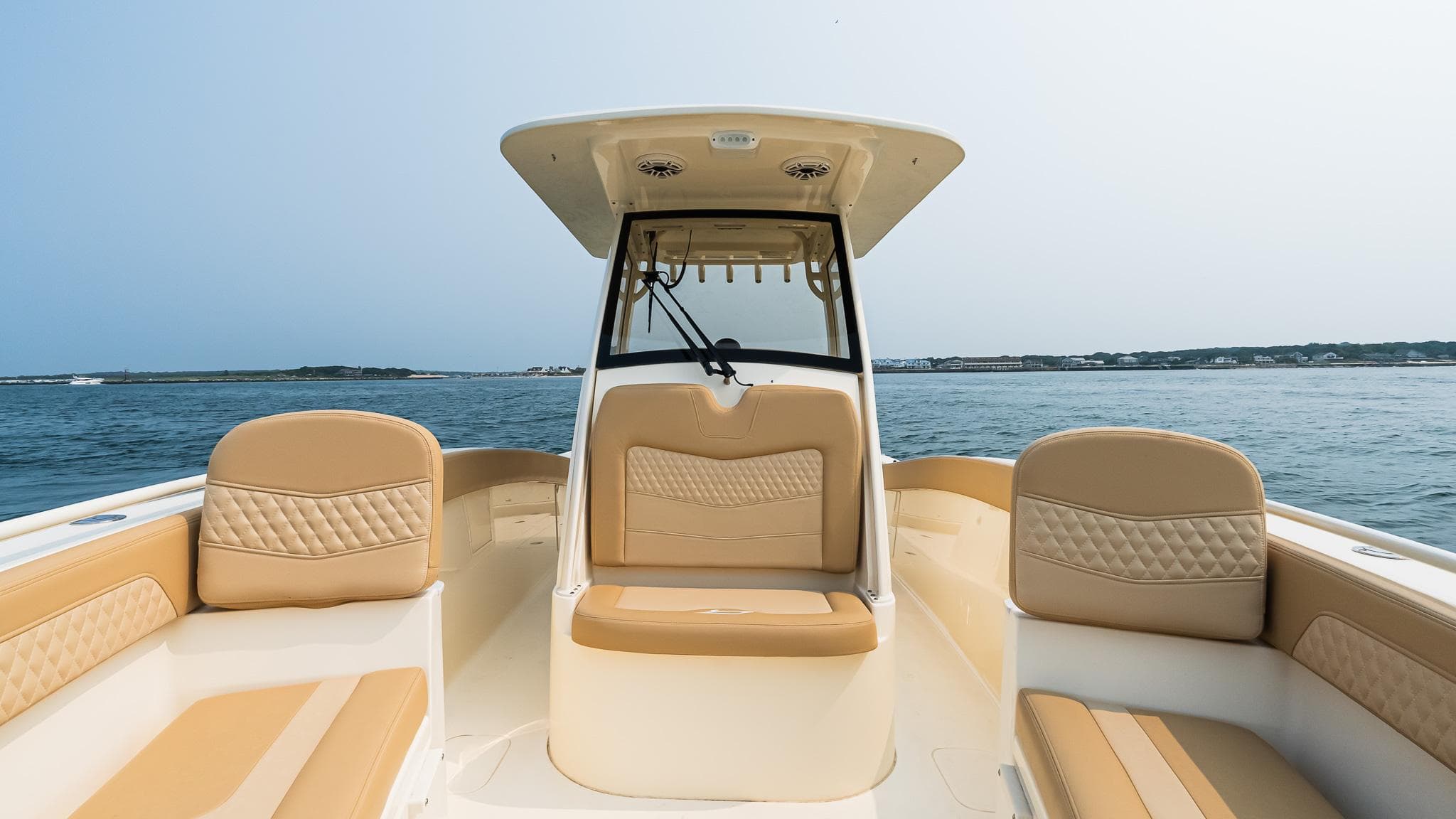 2025 Scout 277 LXF boat interior with tan seating on open water.