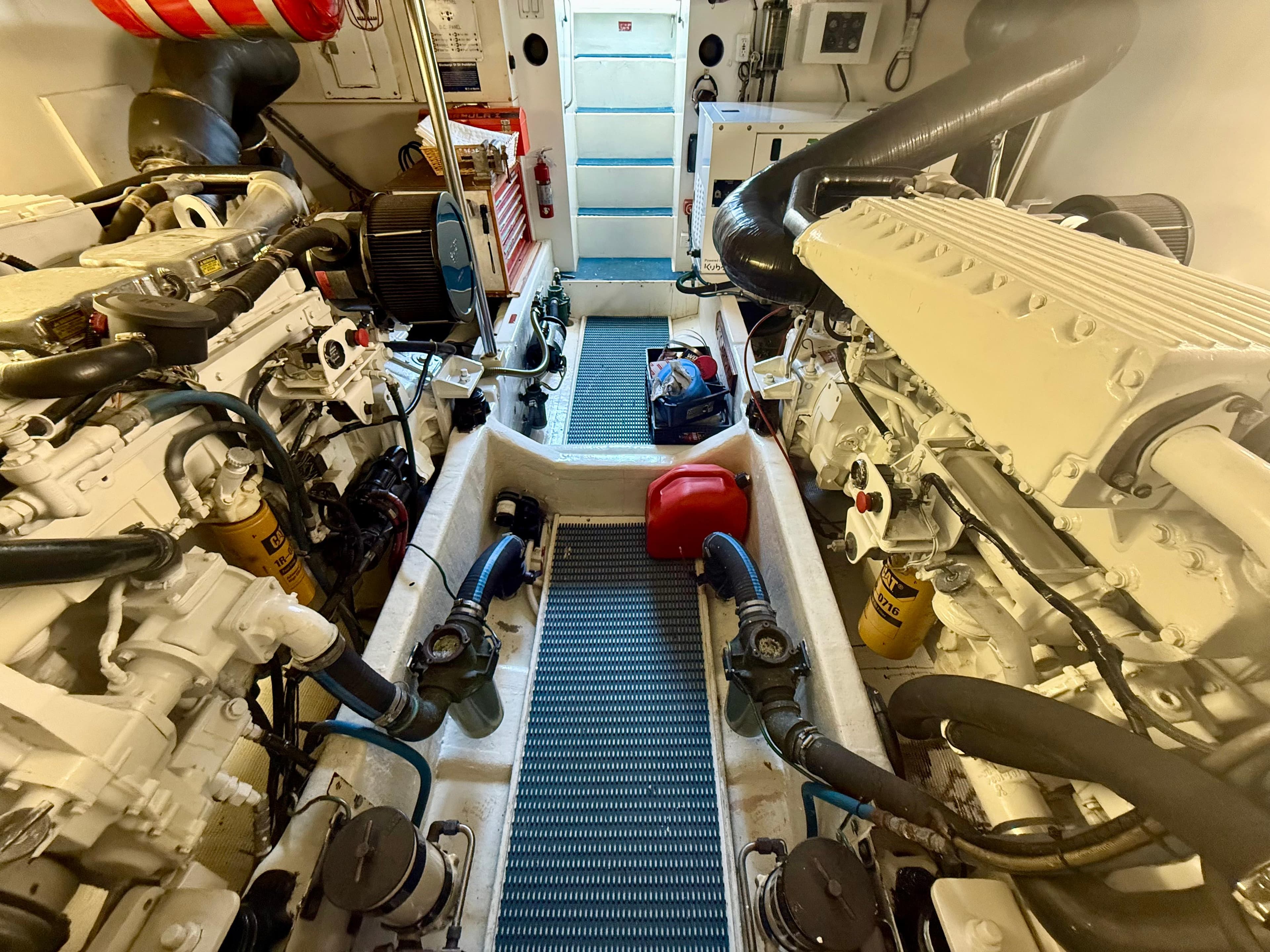 Engine room of 1997 West Bay Sonship 58 Pilothouse with dual engines and equipment.