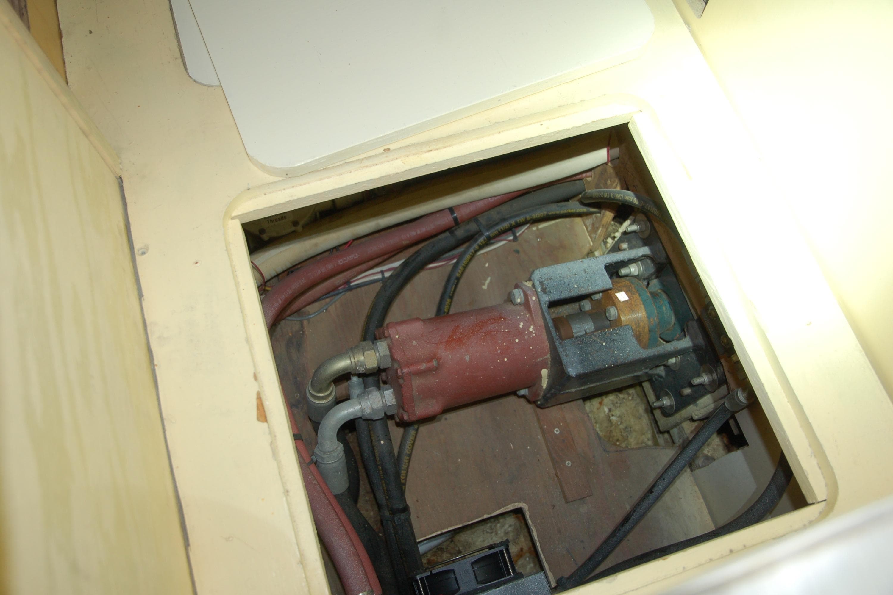 Custom 2006 Sprague mechanical component with hoses and fittings in a compartment.