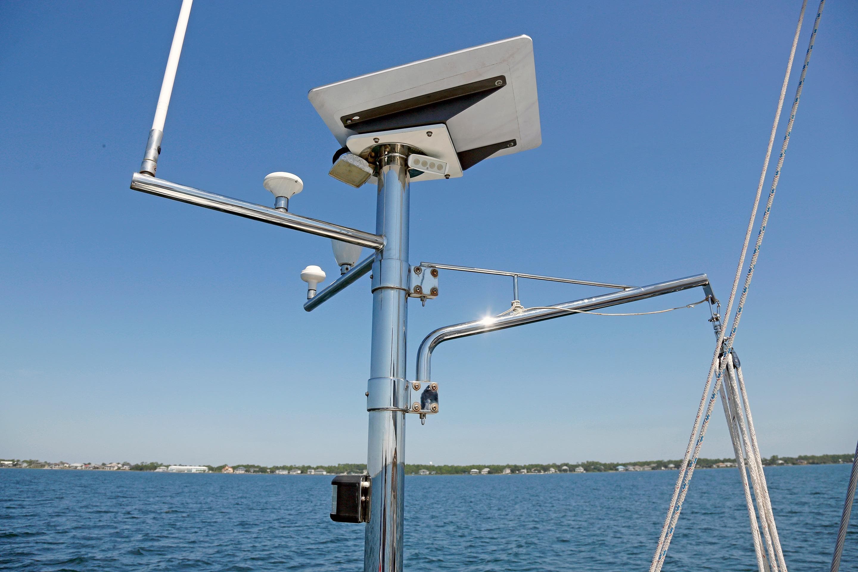 Sailboat radar and antenna setup on a 2012 Hylas 49CC, with clear blue sky background.