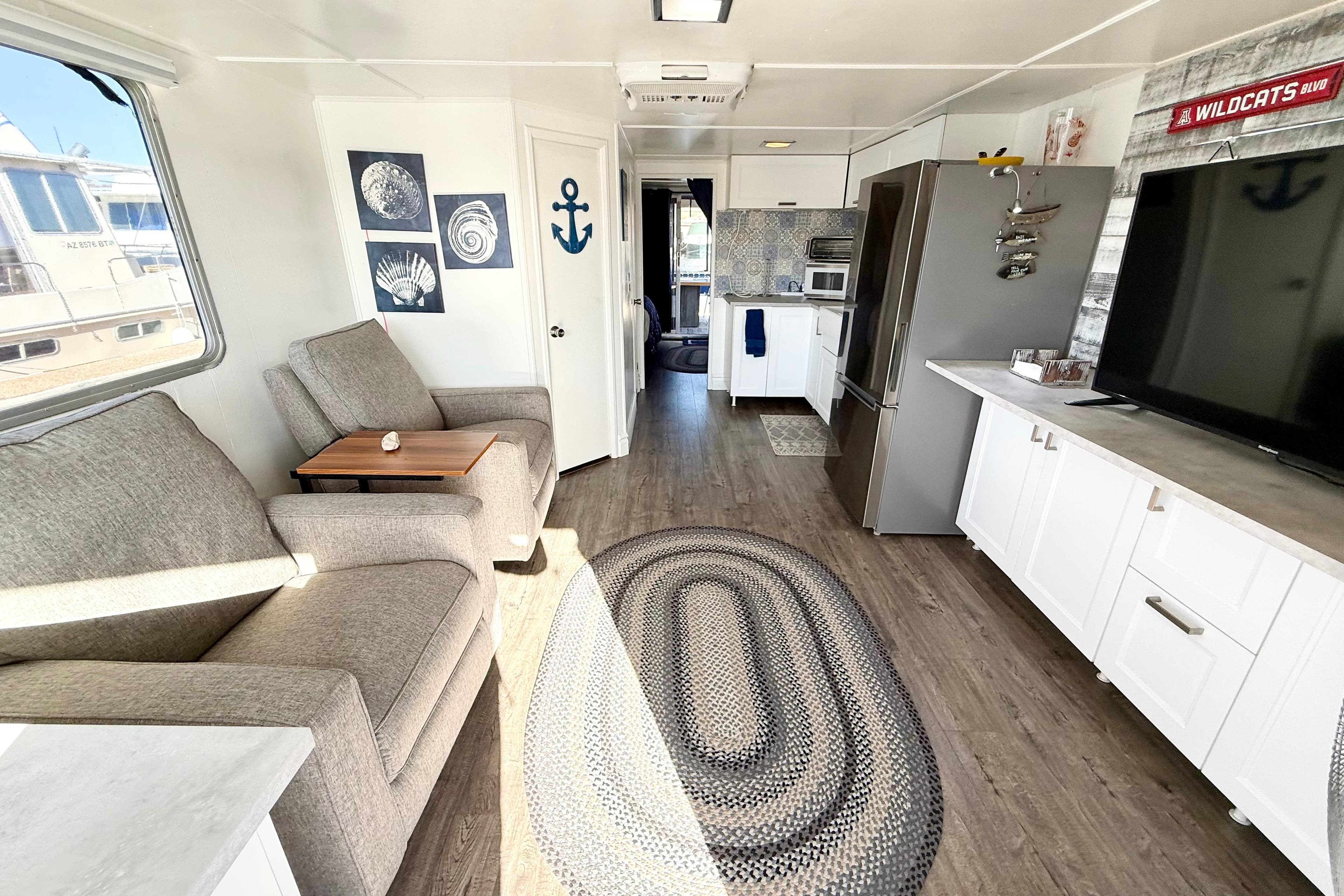 Modern interior of a 1986 Hilburn 4014 Executive houseboat with cozy seating and stylish decor.
