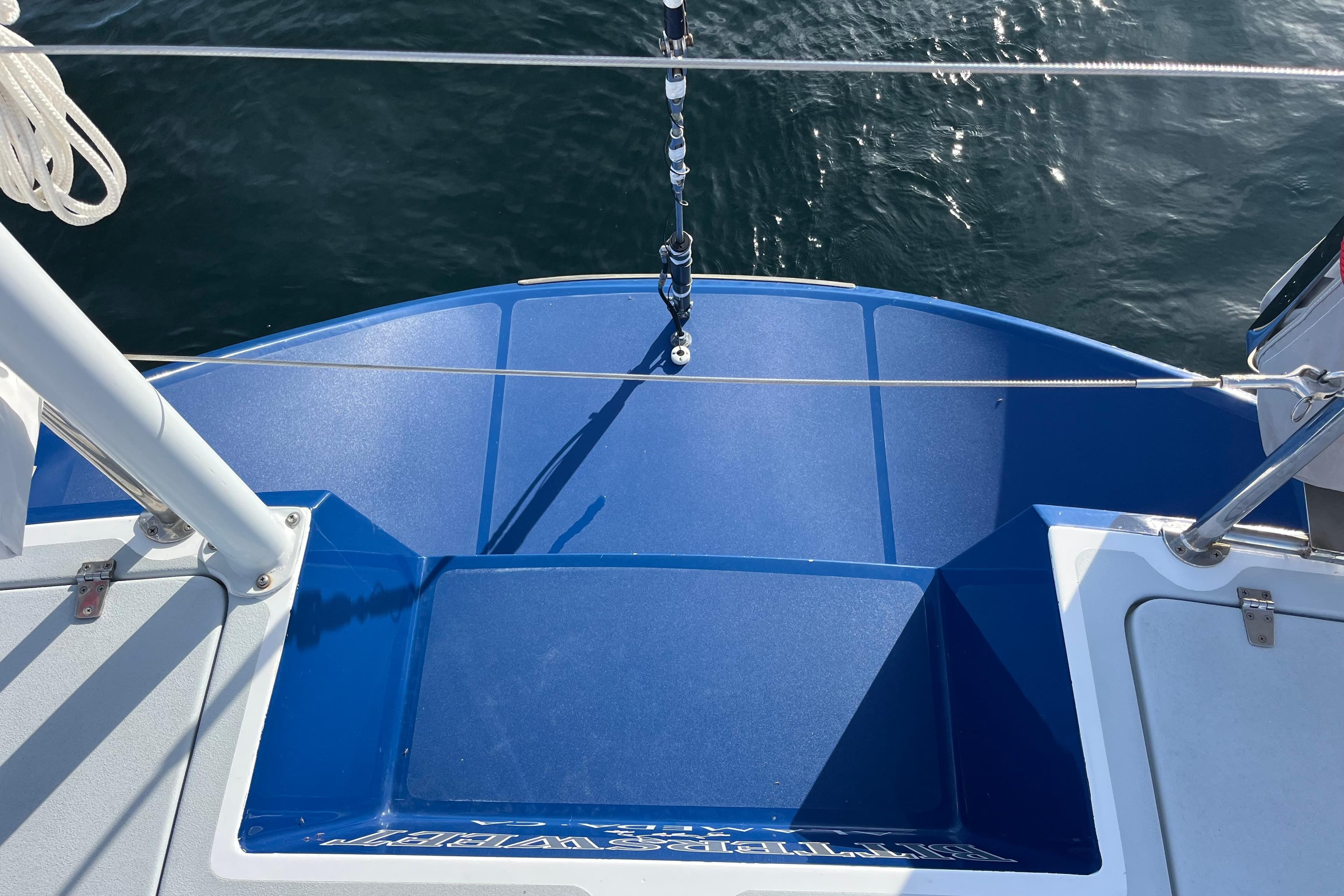 Blue deck of 1995 Able Apogee 50 sailboat with water view.