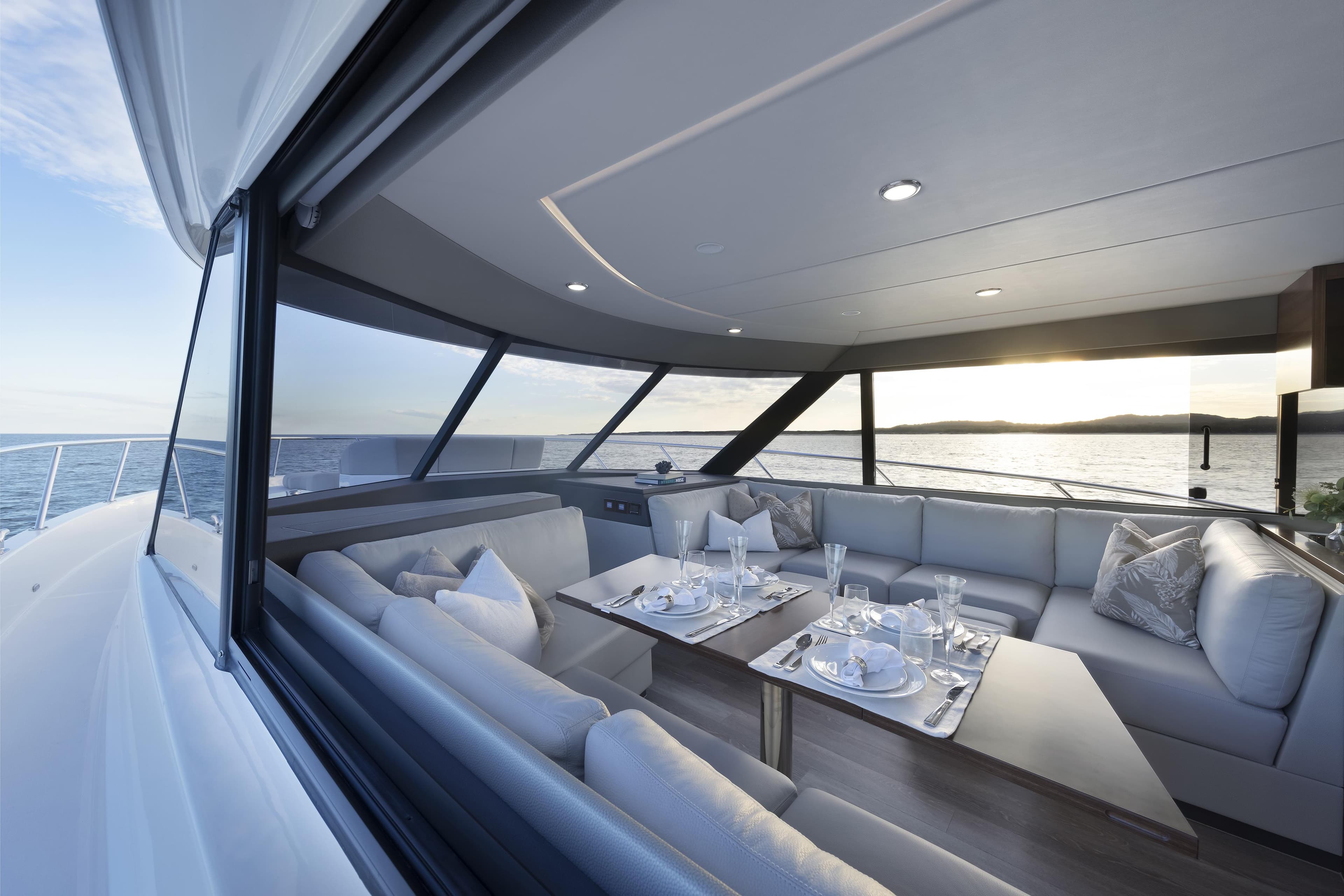 Luxurious interior of 2026 Maritimo M600 yacht with elegant dining setup.