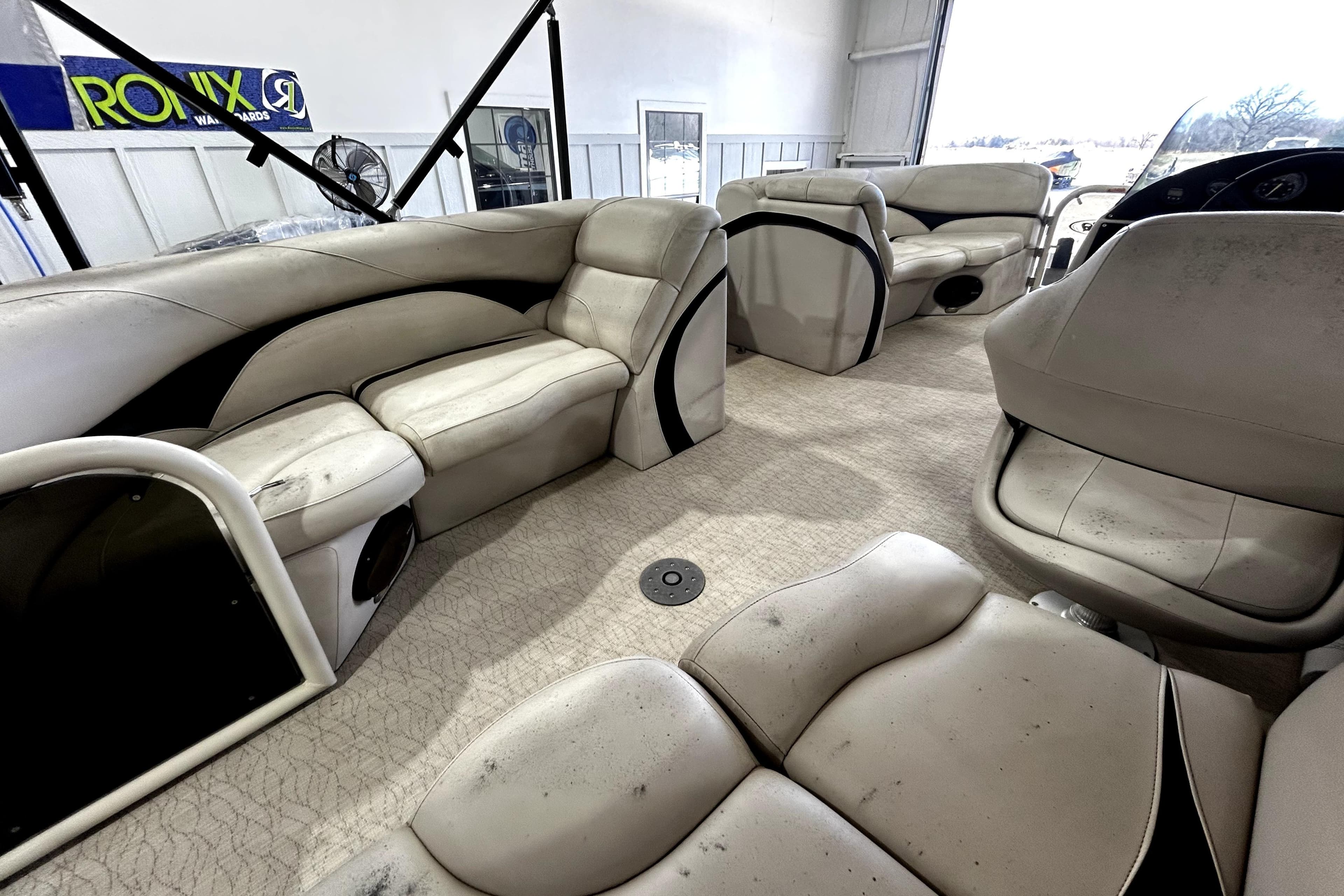 Interior of 2021 Aloha Pontoon Tropical Series with beige seating and spacious layout.