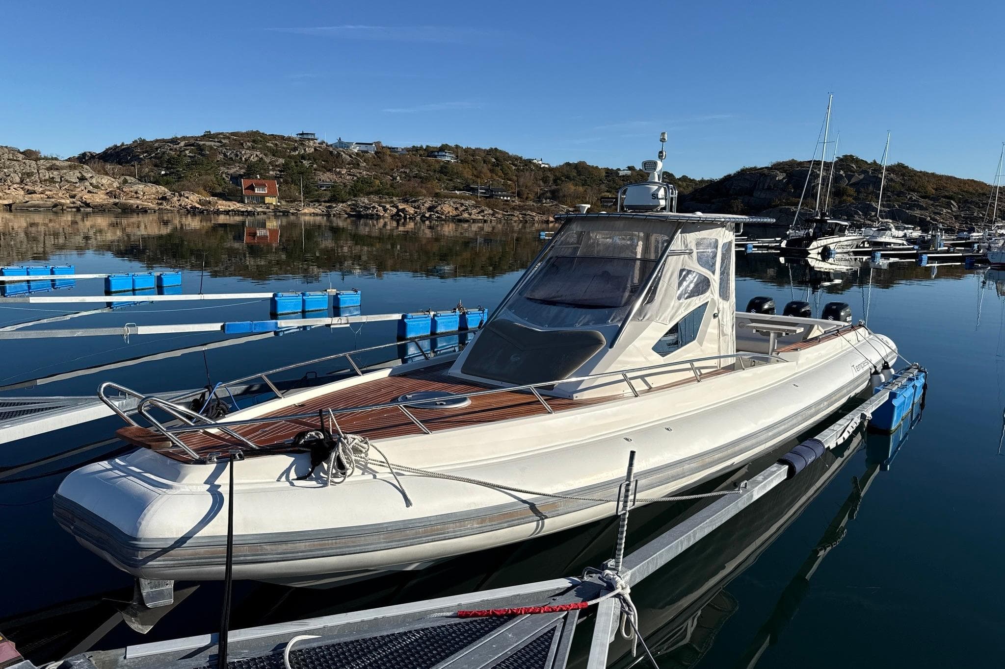 2015 Capelli Tempest 44 boat docked in a serene marina setting.